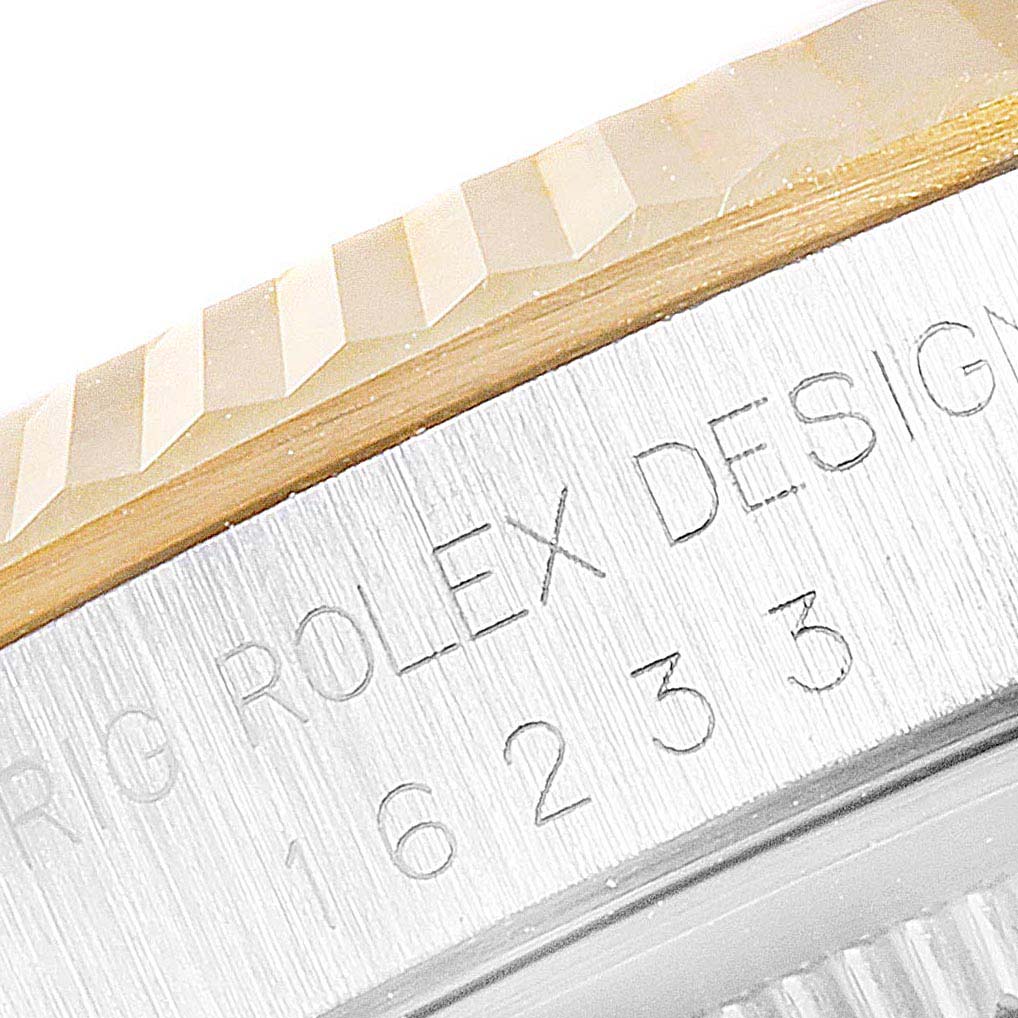 The image shows a close-up of the bezel and engraved side of the case of a Rolex Datejust 16233 Men
s Steel and Gold (two tone) Champagne Dial 16233 Men
s Steel and Gold (two tone) Champagne Dial model.
