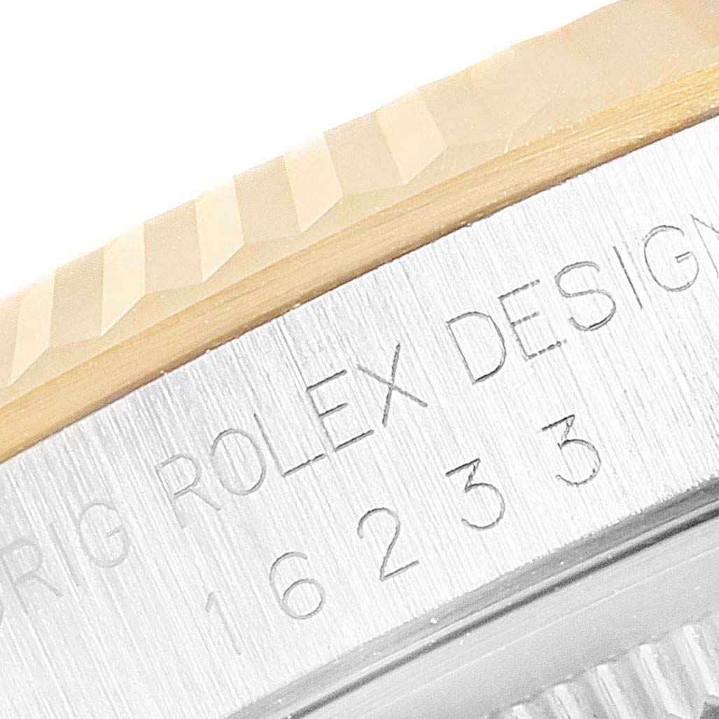 The image shows a close-up of the bezel and the engraved side of the case from the Rolex Datejust 16233 Men
s Steel and Gold (two tone) Champagne Dial 16233 Men
s Steel and Gold (two tone) Champagne Dial model.
