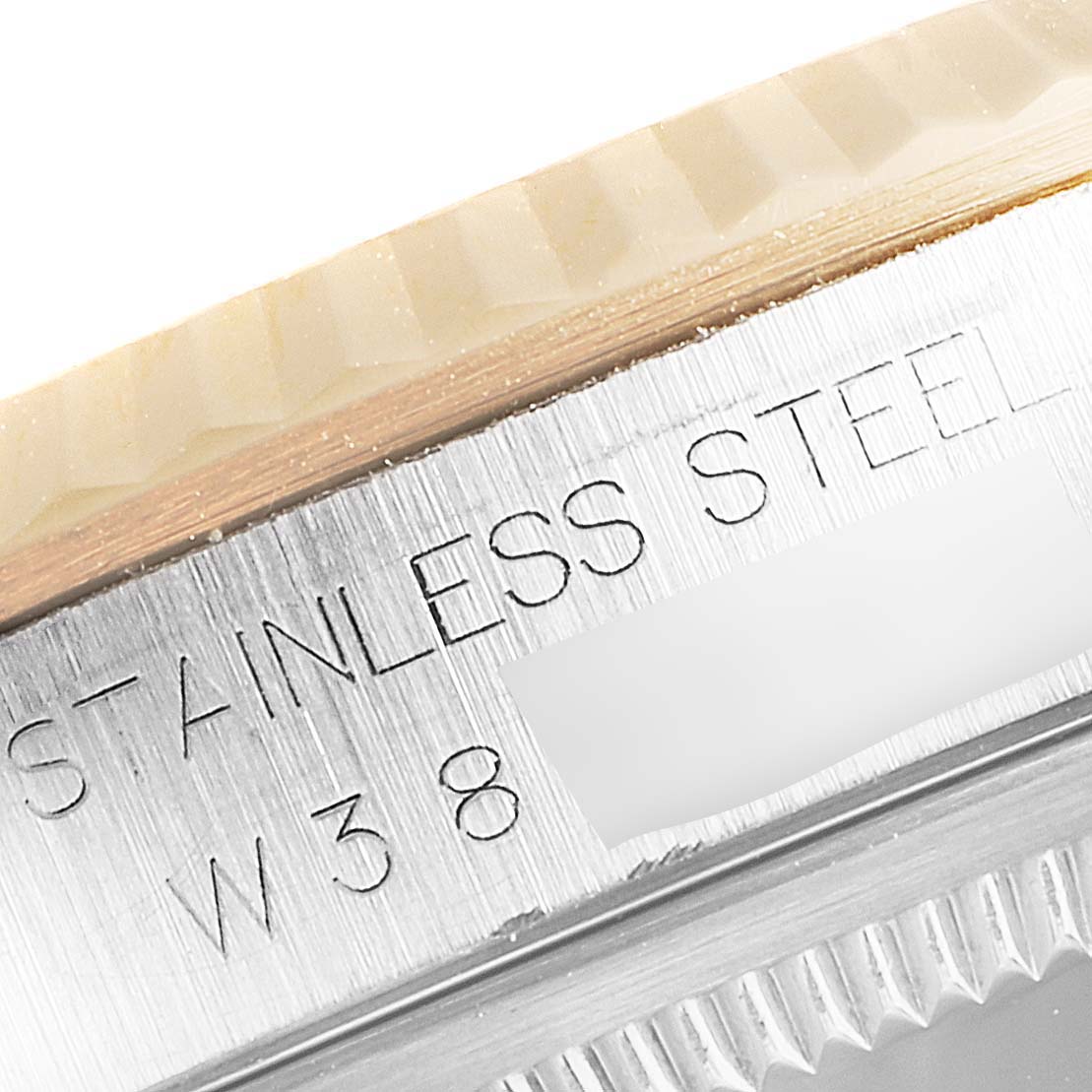 This close-up angle shows the stainless steel engravings and fluted bezel of the Rolex Datejust 16233 Men
s Steel and Gold (two tone) Champagne Dial 16233 Men
s Steel and Gold (two tone) Champagne Dial model.