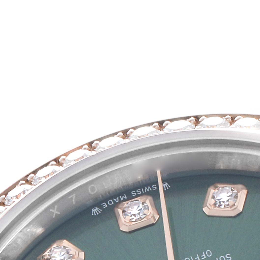 The image shows a partial close-up of a Rolex Datejust 279381 Women's Steel and Gold (two tone) Green Dial watch dial with diamond hour markers and a jeweled bezel.