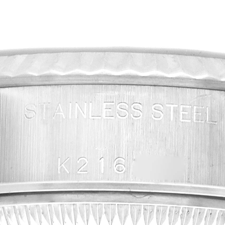 The image shows the side engravings on a stainless steel Rolex Datejust 79174 Women's Stainless Steel Silver Dial bezel, showcasing machining details.