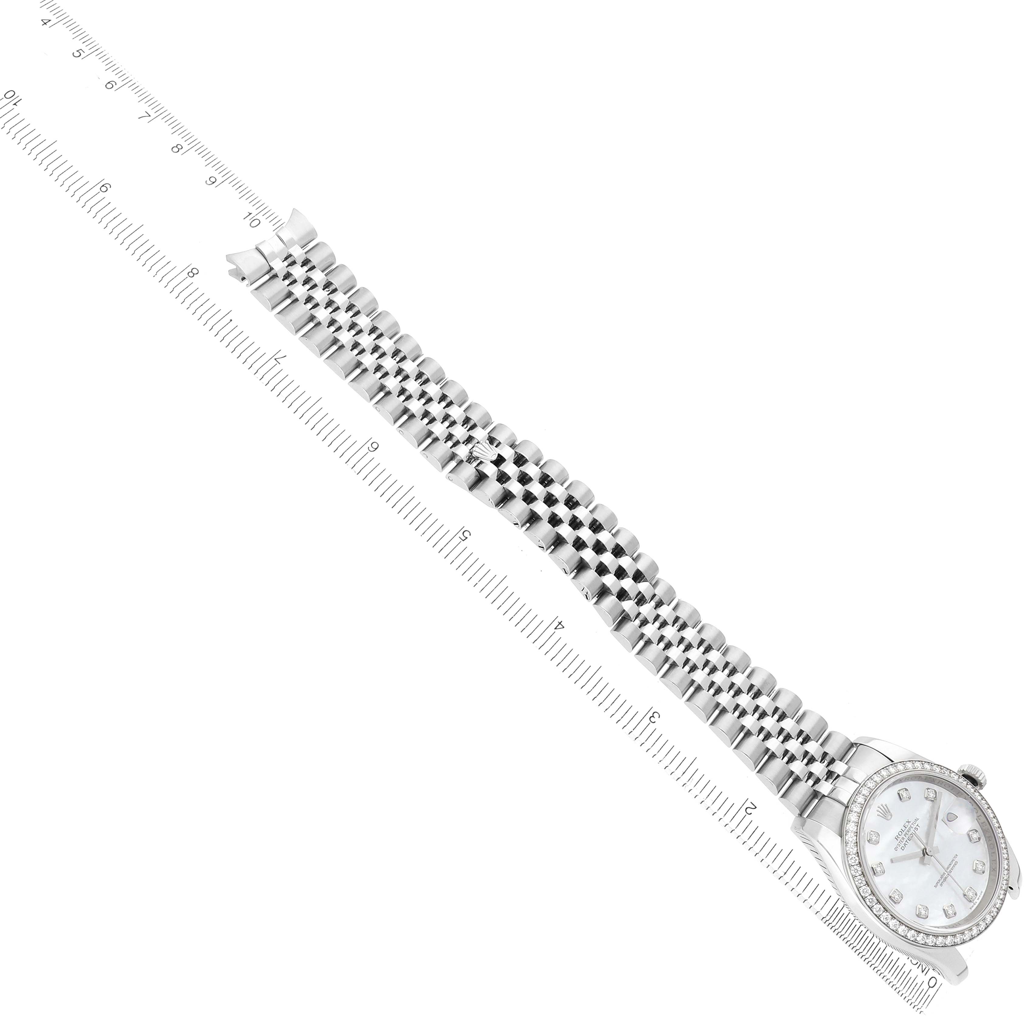 The Rolex Datejust 116244 Men
s Stainless Steel Mother of Pearl Dial watch is shown from a top-down angle, highlighting the face and the length of the bracelet next to a ruler.