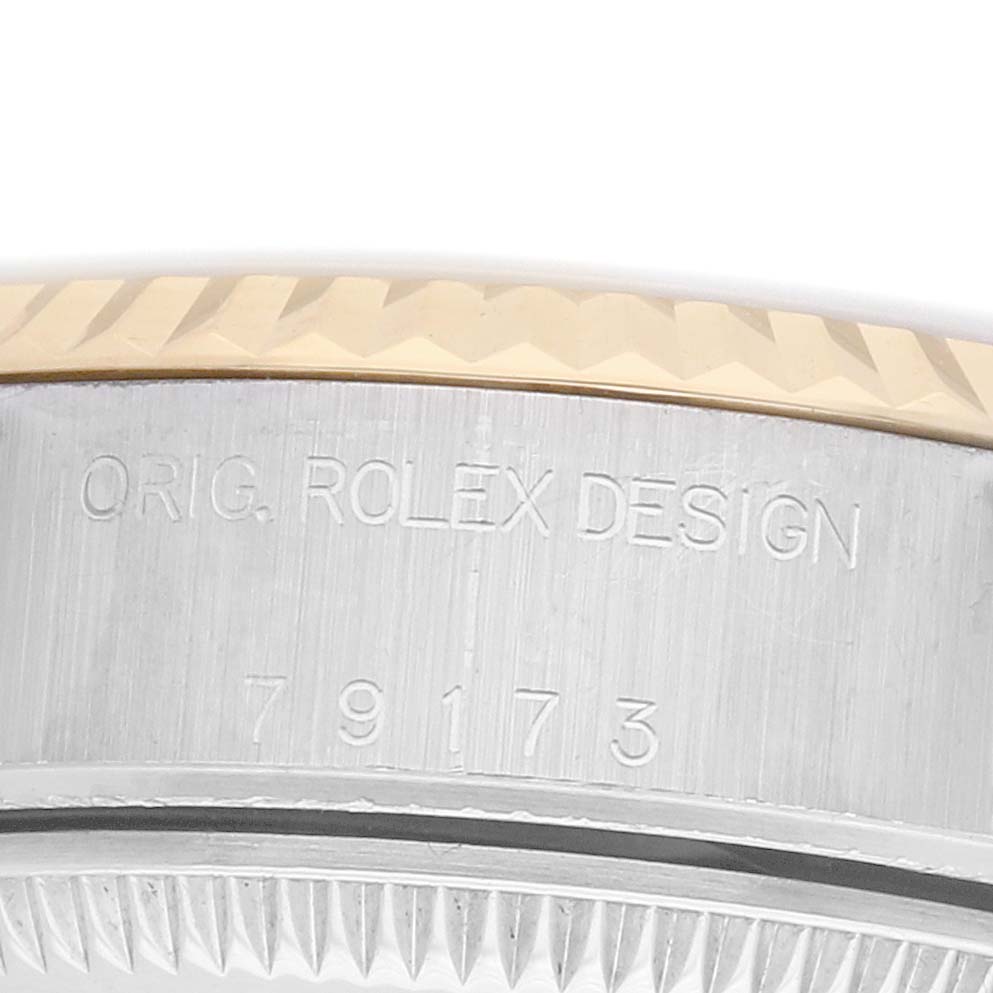 The image shows a close-up angle of the side of a Rolex Datejust 79173 Women's Steel and Gold (two tone) Champagne Dial, highlighting the model number and "Orig. Rolex Design" engraving.