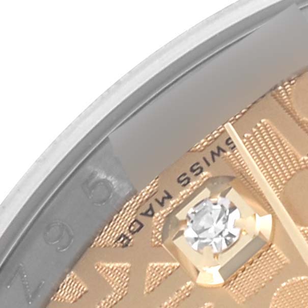 The close-up image shows part of the dial and diamond hour marker of a Rolex Datejust 116233 Men
s Steel and Gold (two tone) Champagne Dial 116233 Men
s Steel and Gold (two tone) Champagne Dial.