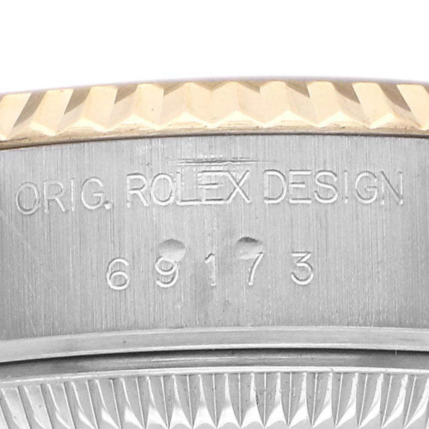 The image shows a close-up of the side of a Rolex Datejust 69173 Women's Steel and Gold (two tone) Champagne Dial watch case, focusing on the model number and bezel edge.