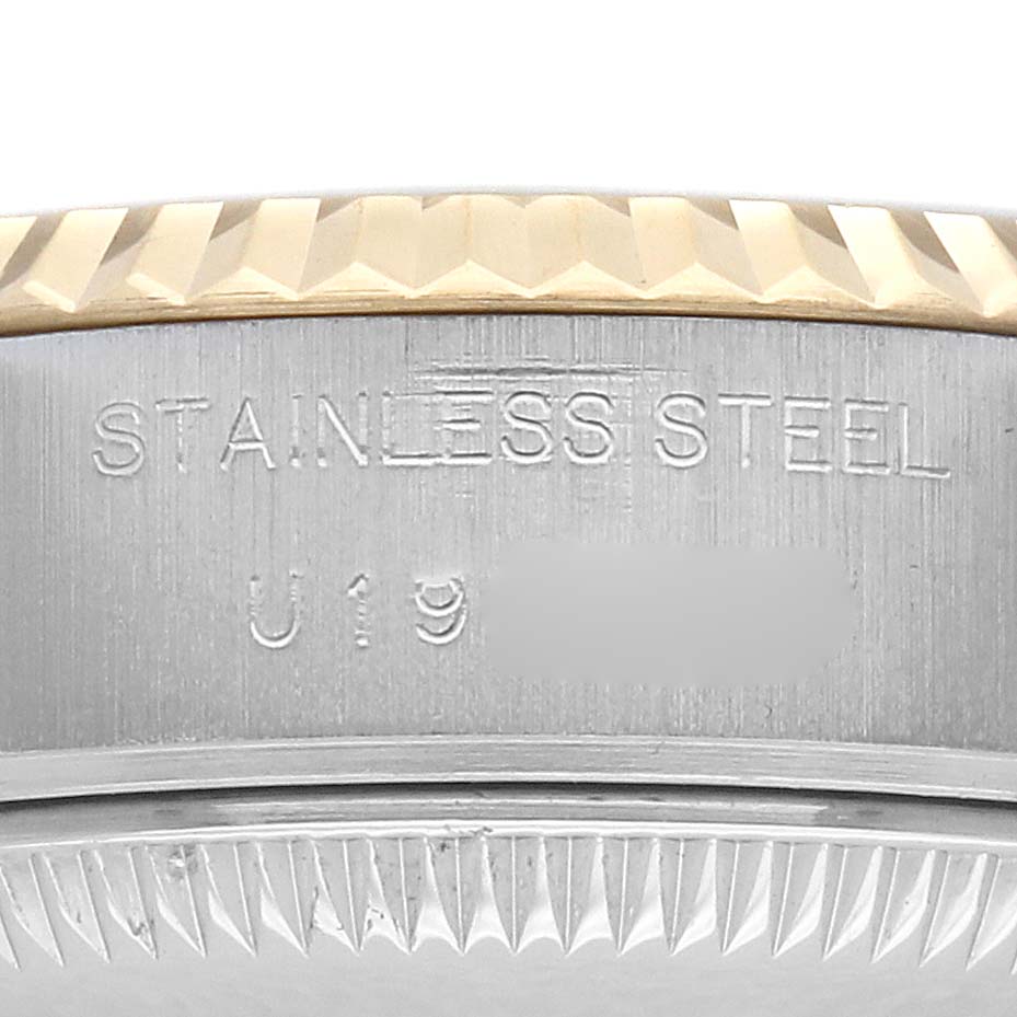 The image shows a close-up of the Rolex Datejust 69173 Women's Steel and Gold (two tone) Champagne Dial's case side, highlighting the "STAINLESS STEEL" engraving.