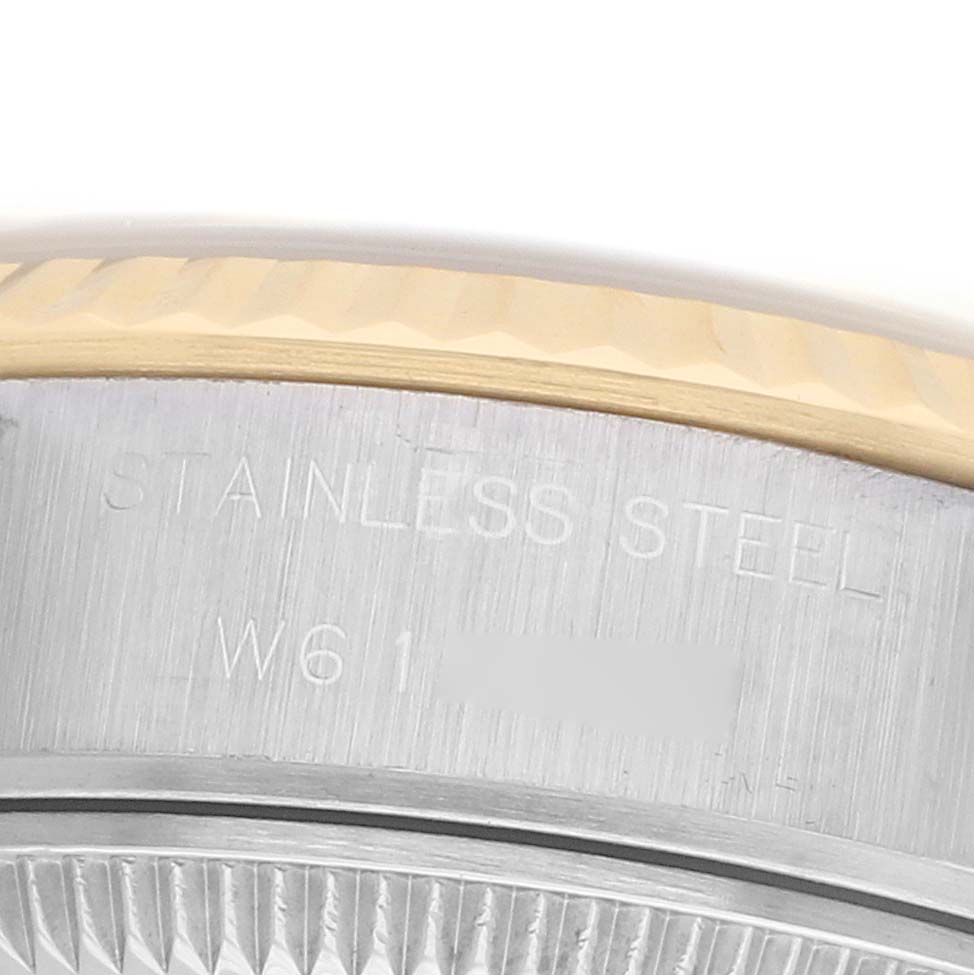 The image shows an angled view of the stainless steel case edge and fluted bezel on a Rolex Datejust 69173 Women
s Steel and Gold (two tone) Black Dial watch.