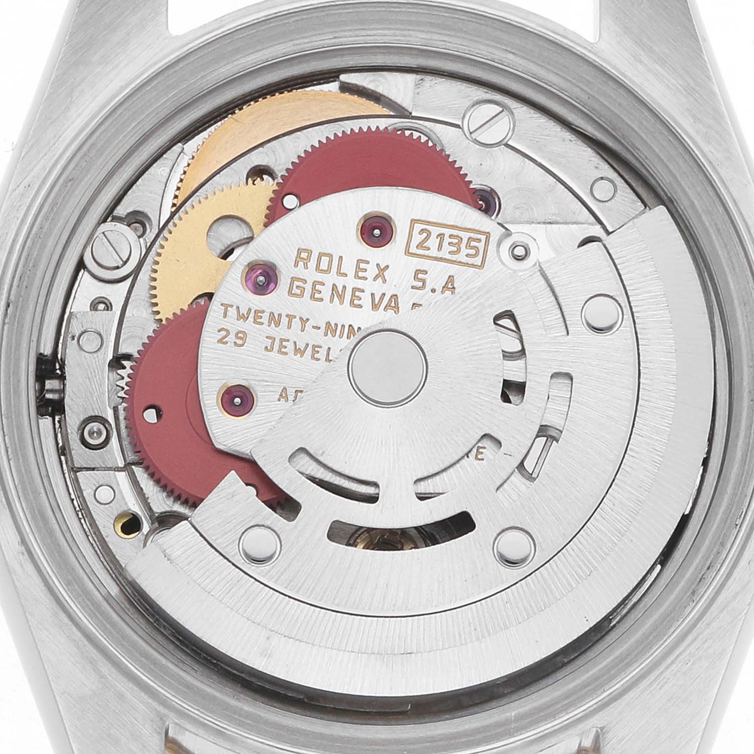 The image shows the movement of a Rolex Datejust 69173 Women
s Steel and Gold (two tone) Black Dial watch viewed from the back, highlighting gears and jewels.