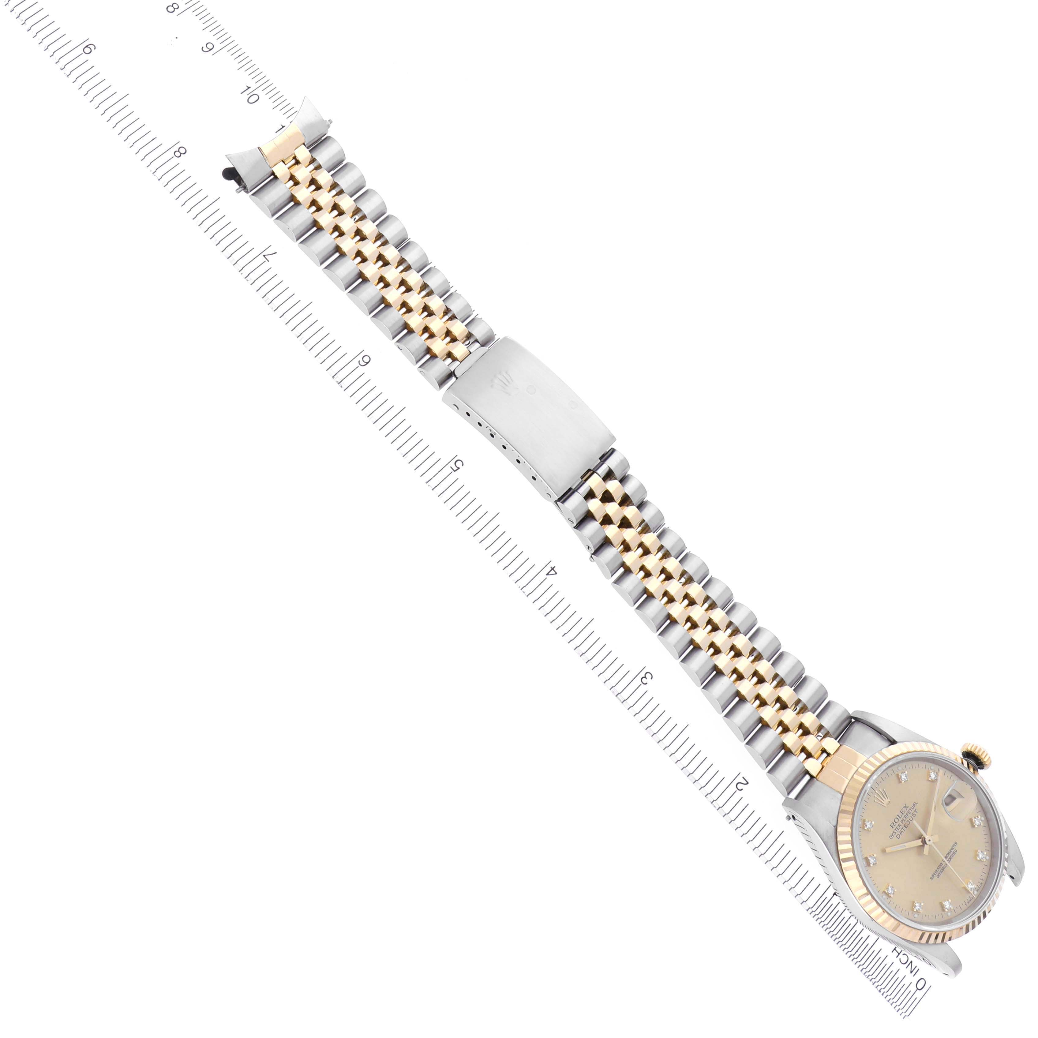 The image shows a Rolex Datejust 16233 Men
s Steel and Gold (two tone) Champagne Dial 16233 Men
s Steel and Gold (two tone) Champagne Dial watch laid flat, displaying the full two-tone bracelet and face at an angled perspective.