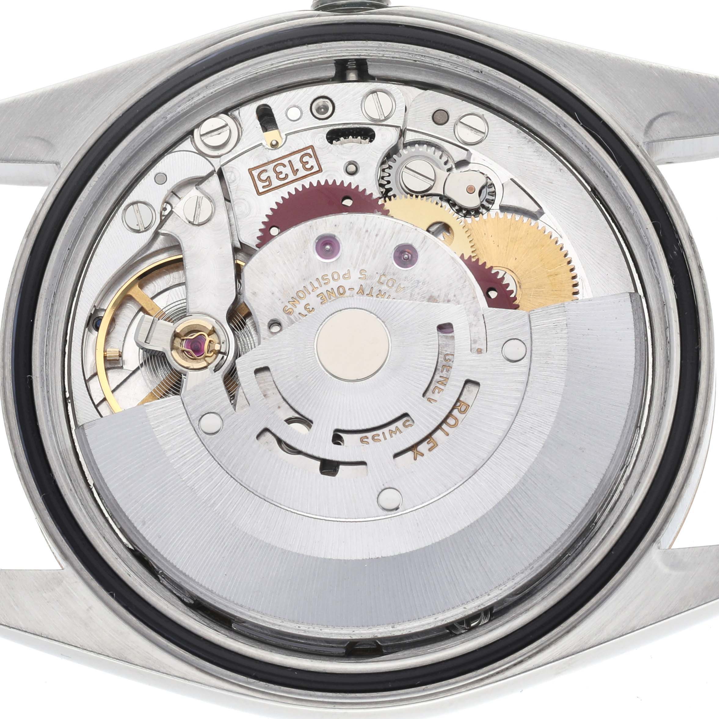 The image shows the back view of a Rolex Datejust 16233 Men's Steel and Gold (two tone) Champagne Dial 16233 Men's Steel and Gold (two tone) Champagne Dial, displaying its intricate movement and gears.