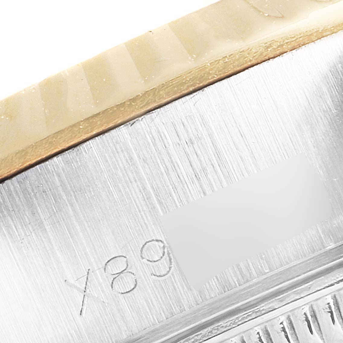 This close-up image shows the side of a Rolex Datejust 69173 Women's Steel and Gold (two tone) Mother of Pearl Dial 69173 Women's Steel and Gold (two tone) Mother of Pearl Dial watch, focusing on the brushed metal case and part of the serial number.