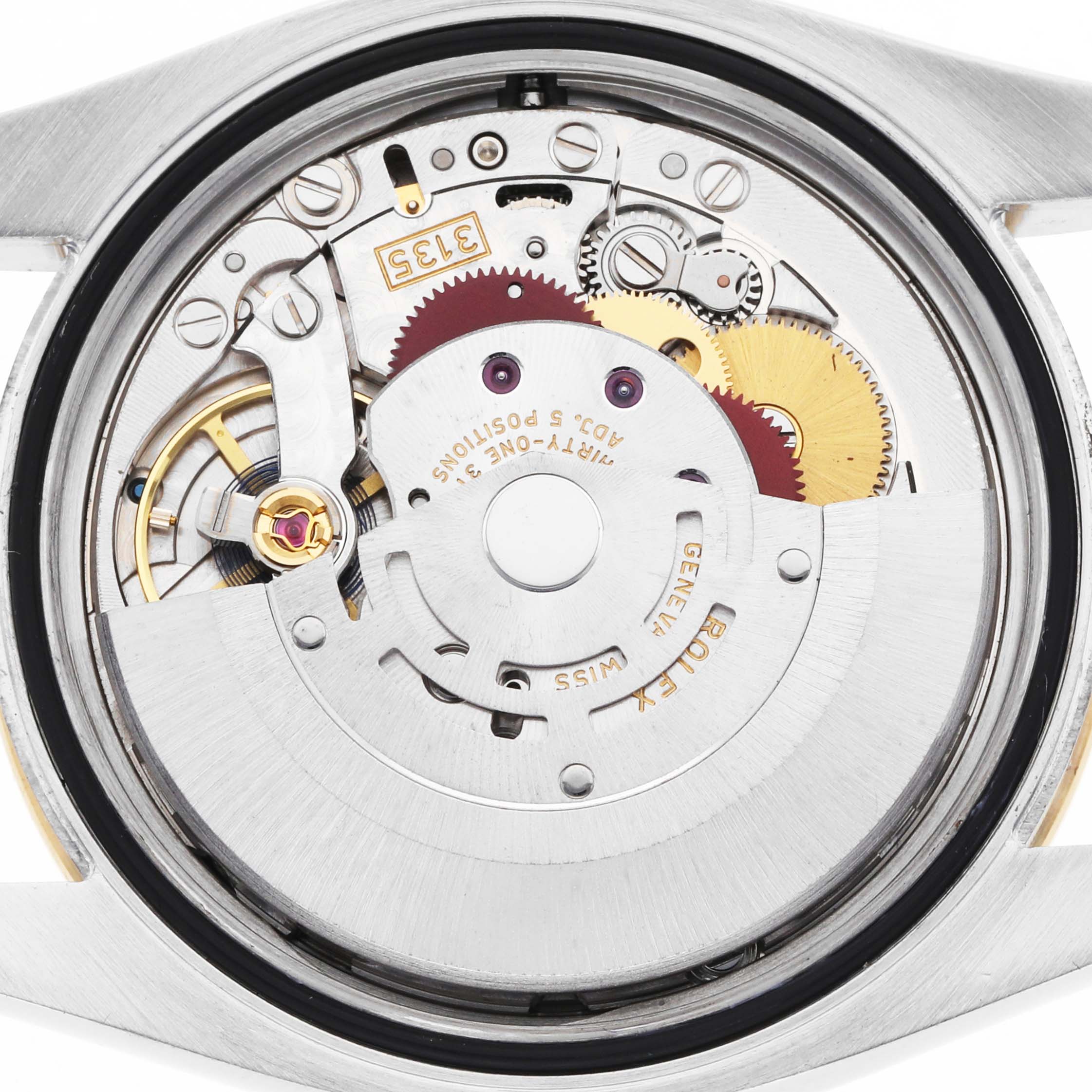 The image shows the movement of a Rolex Datejust 116243 Men
s Steel and Gold (two tone) Silver Dial from a back angle, highlighting gears and mechanical components.