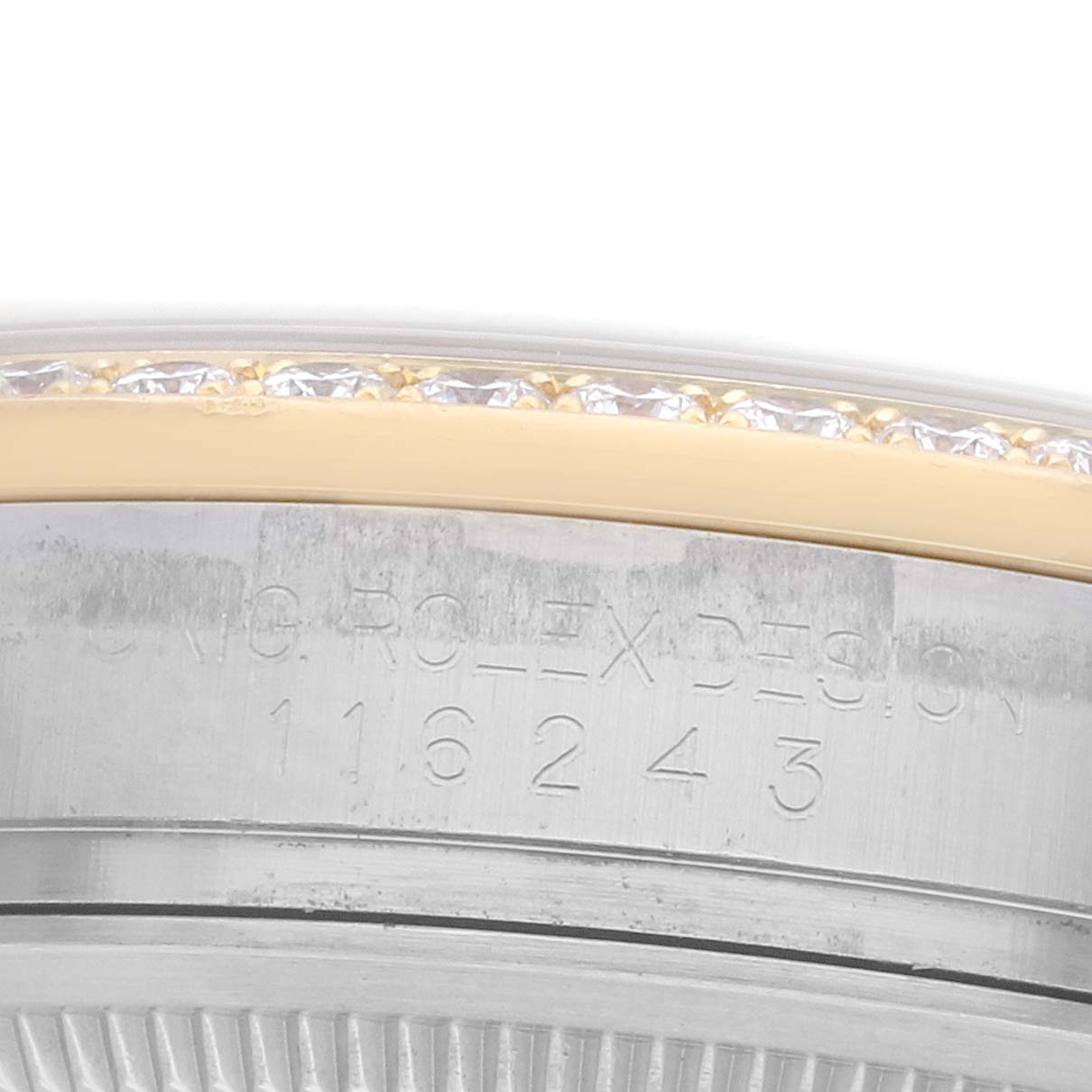The image shows a close-up of the case side and part of the bezel of a Rolex Datejust 116243 Men
s Steel and Gold (two tone) Silver Dial watch, highlighting engravings.