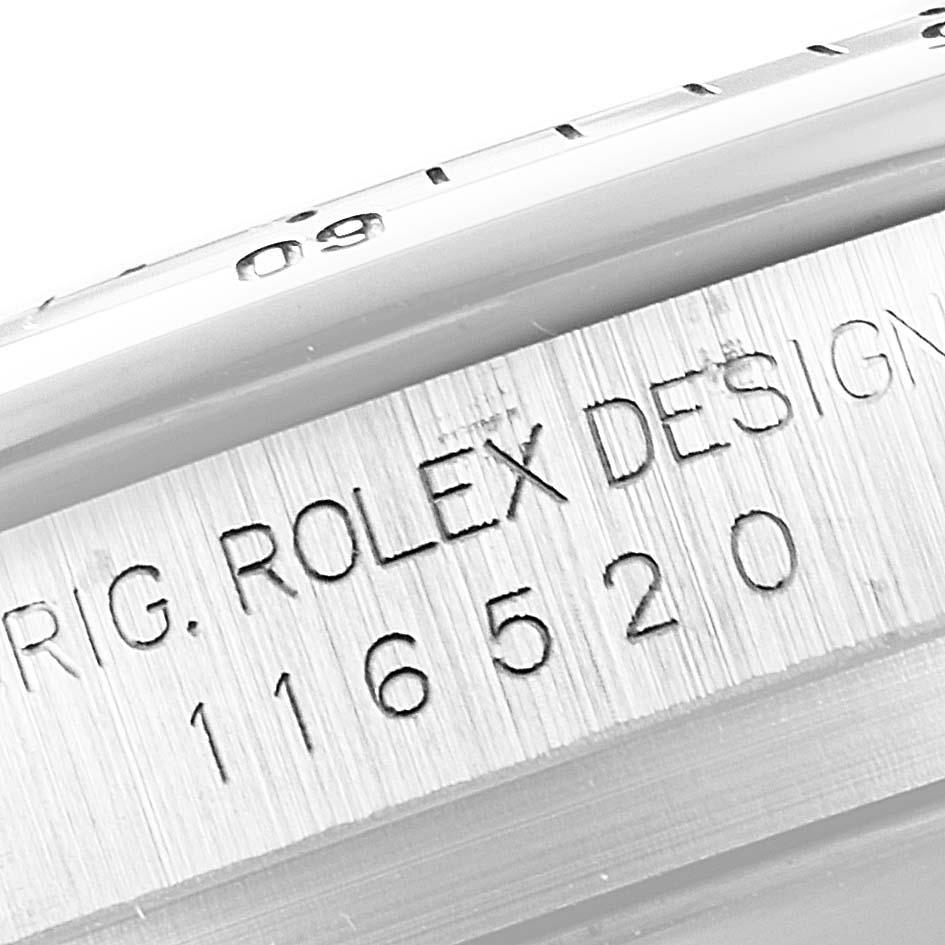This close-up image shows the engraved model number and "ROLEX DESIGN" on the side of a Rolex Daytona 116520 Men's Stainless Steel White Dial 116520 Men's Stainless Steel White Dial watch case.