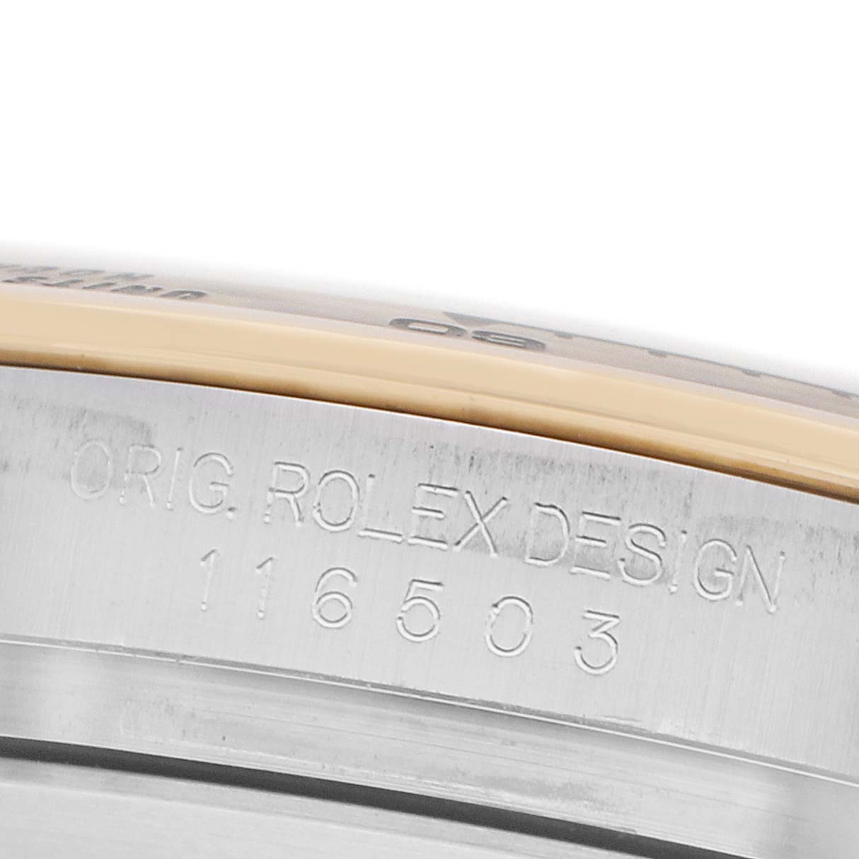 The image shows the side view of a Rolex Daytona 116503 Men
s Steel and Gold (two tone) Champagne Dial model, focusing on the engraved design code on the case.