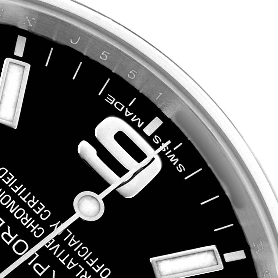 The image shows a close-up of the Rolex Explorer 214270 Men
s Stainless Steel Black Dial
s dial, highlighting the "Swiss Made" mark and partial hour markers.