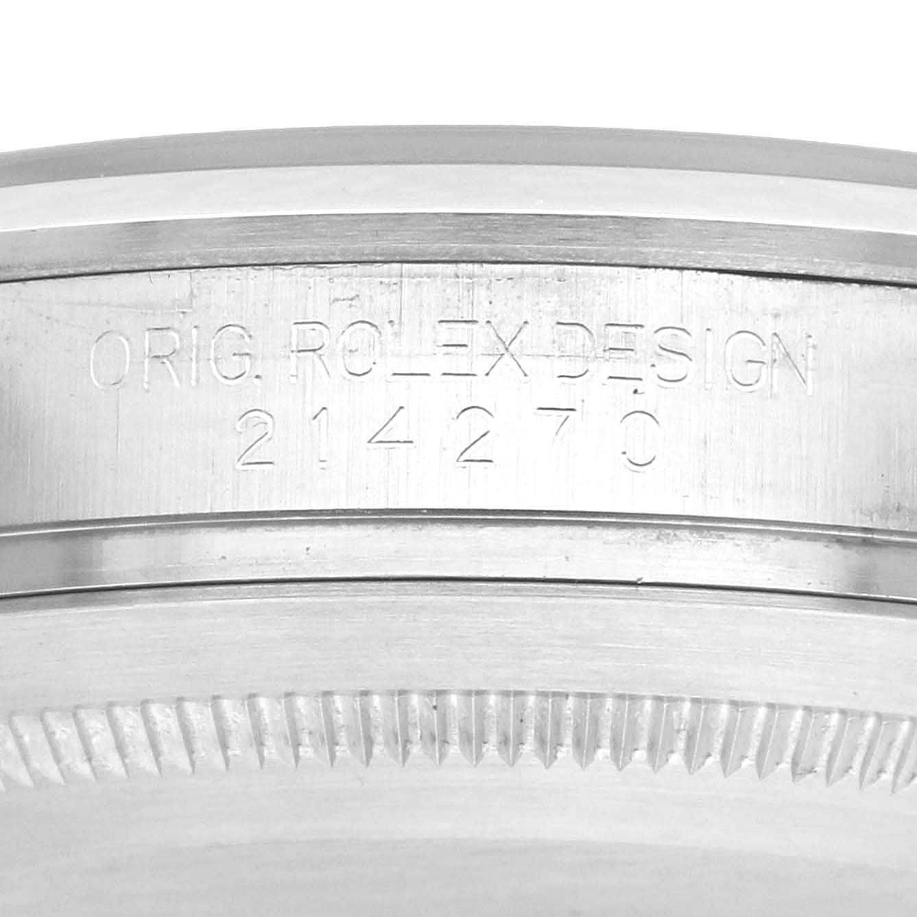 The image shows a close-up of the side of a Rolex Explorer 214270 Men
s Stainless Steel Black Dial model, focusing on the engraved serial and model number.