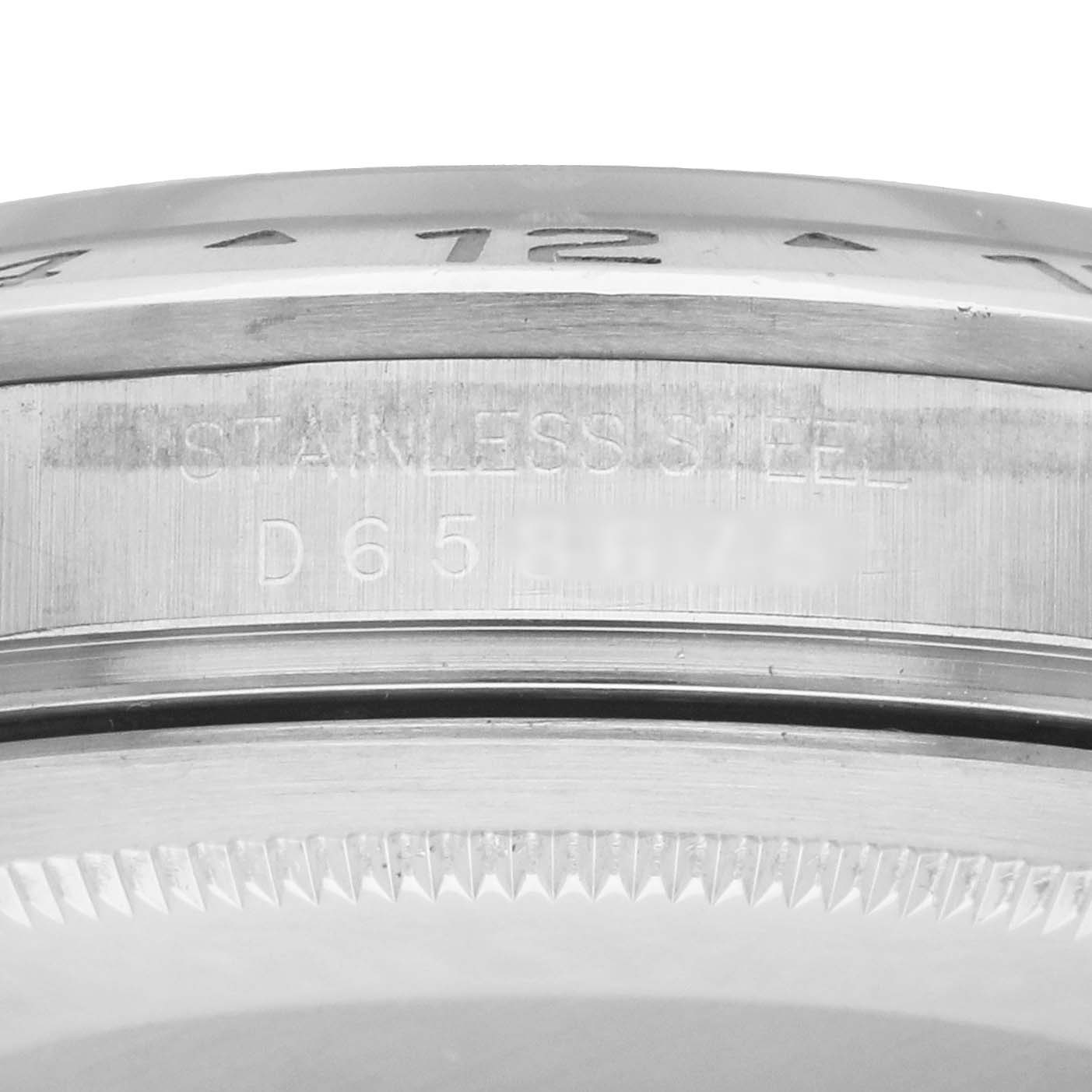 The image shows a close-up of the side engraving and bezel of a Rolex Explorer 16570 Men
s Stainless Steel White Dial watch.