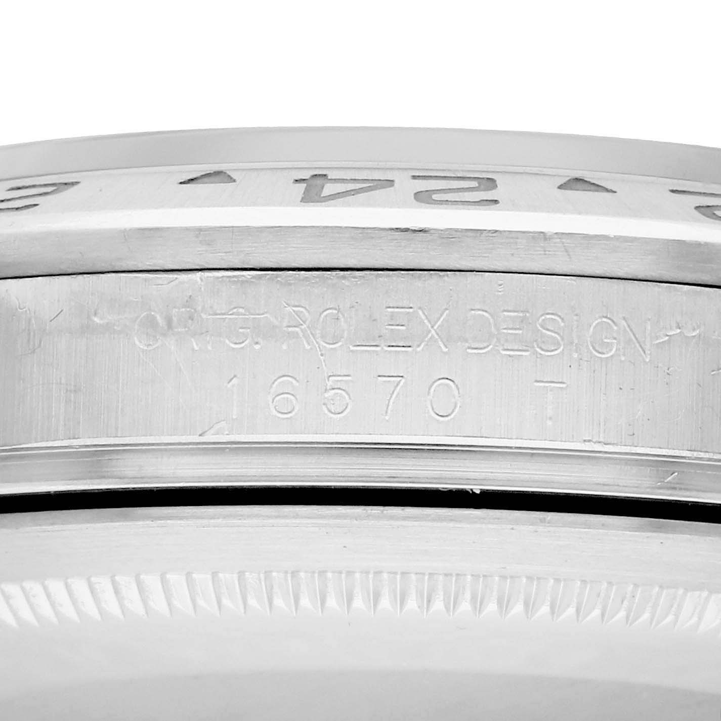 The image presents a close-up of the case side of a Rolex Explorer 16570 Men
s Stainless Steel White Dial model, showing the model number and Rolex engraving.