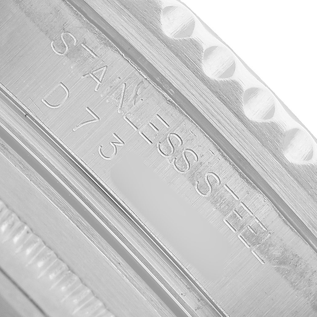 The image shows a close-up of the inner engraving on the case of a Rolex GMT-Master 16710 Men's Stainless Steel Black Dial, highlighting the "STAINLESS STEEL" marking.