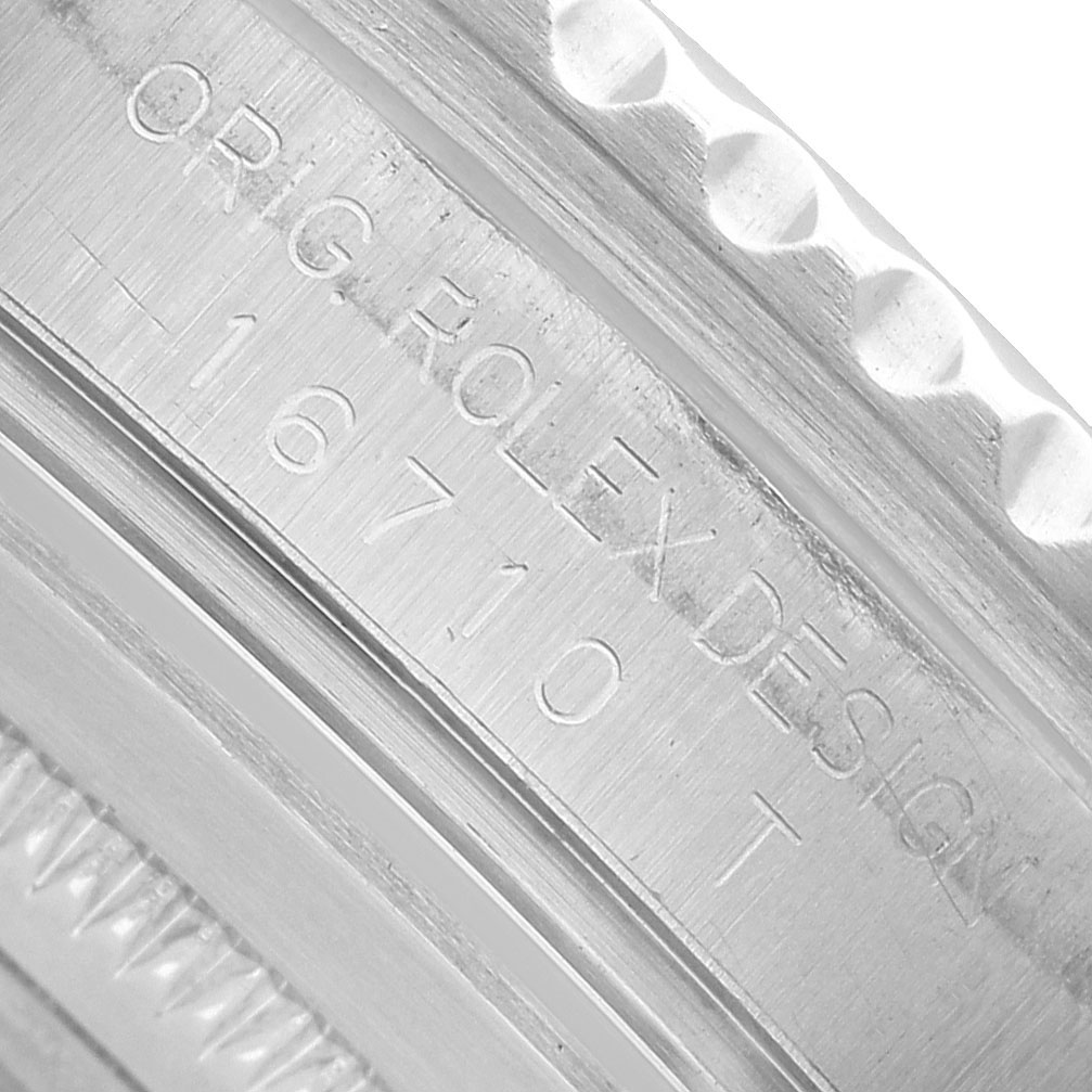 The image shows a close-up of the Rolex GMT-Master 16710 Men's Stainless Steel Black Dial 16710 reference number engraved on the watch case.