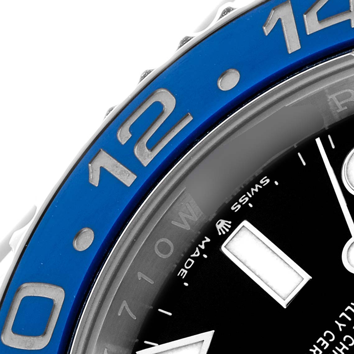 The image shows a close-up of the bezel and part of the dial of a Rolex GMT-Master 126710 Men
s Stainless Steel Black Dial, focusing on the blue section with numbers.