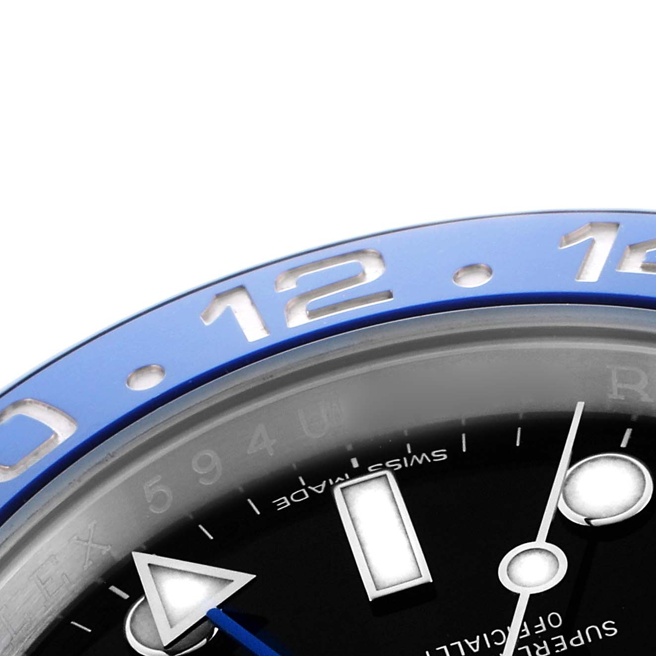The image shows a close-up of the bezel and part of the dial on the Rolex GMT-Master 116710BLNR Men's Stainless Steel Black Dial, highlighting the blue bezel and indices.