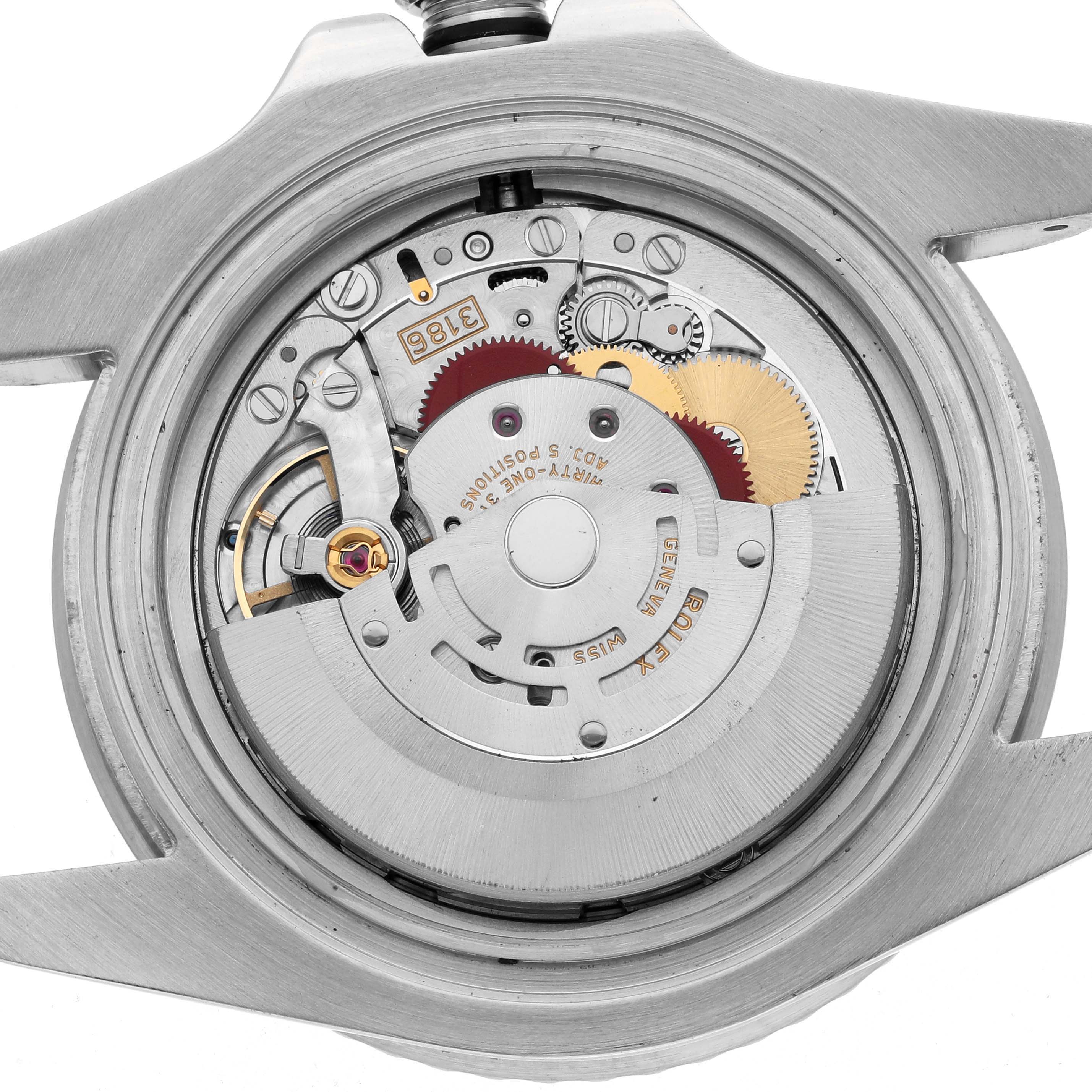 The image shows the open case back of a Rolex GMT-Master 116710 Men
s Stainless Steel Black Dial, revealing its internal mechanical movement.