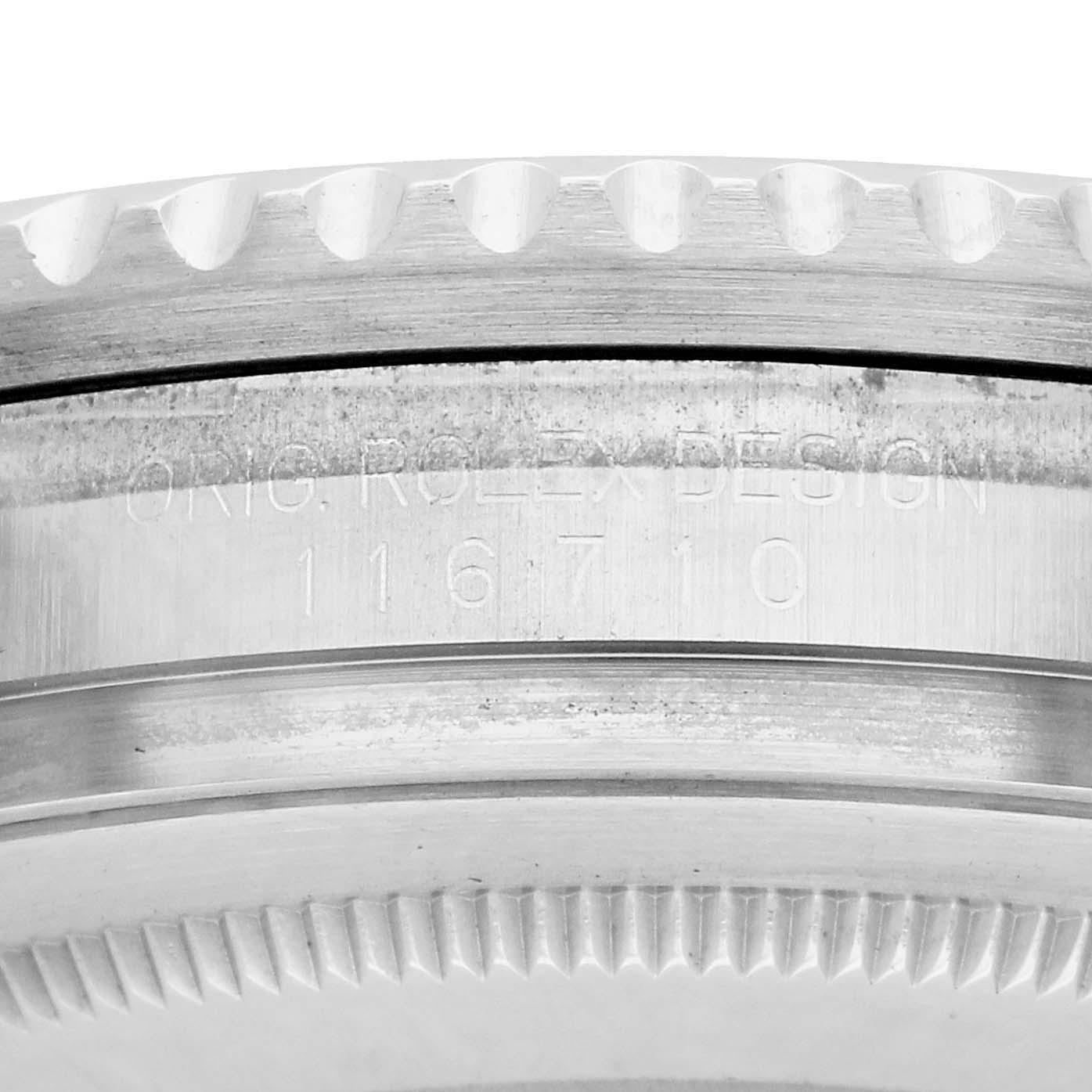 The image shows a close-up of the bezel and case engravings on a Rolex GMT-Master 116710LN Men's Stainless Steel Black Dial watch, highlighting the model number.
