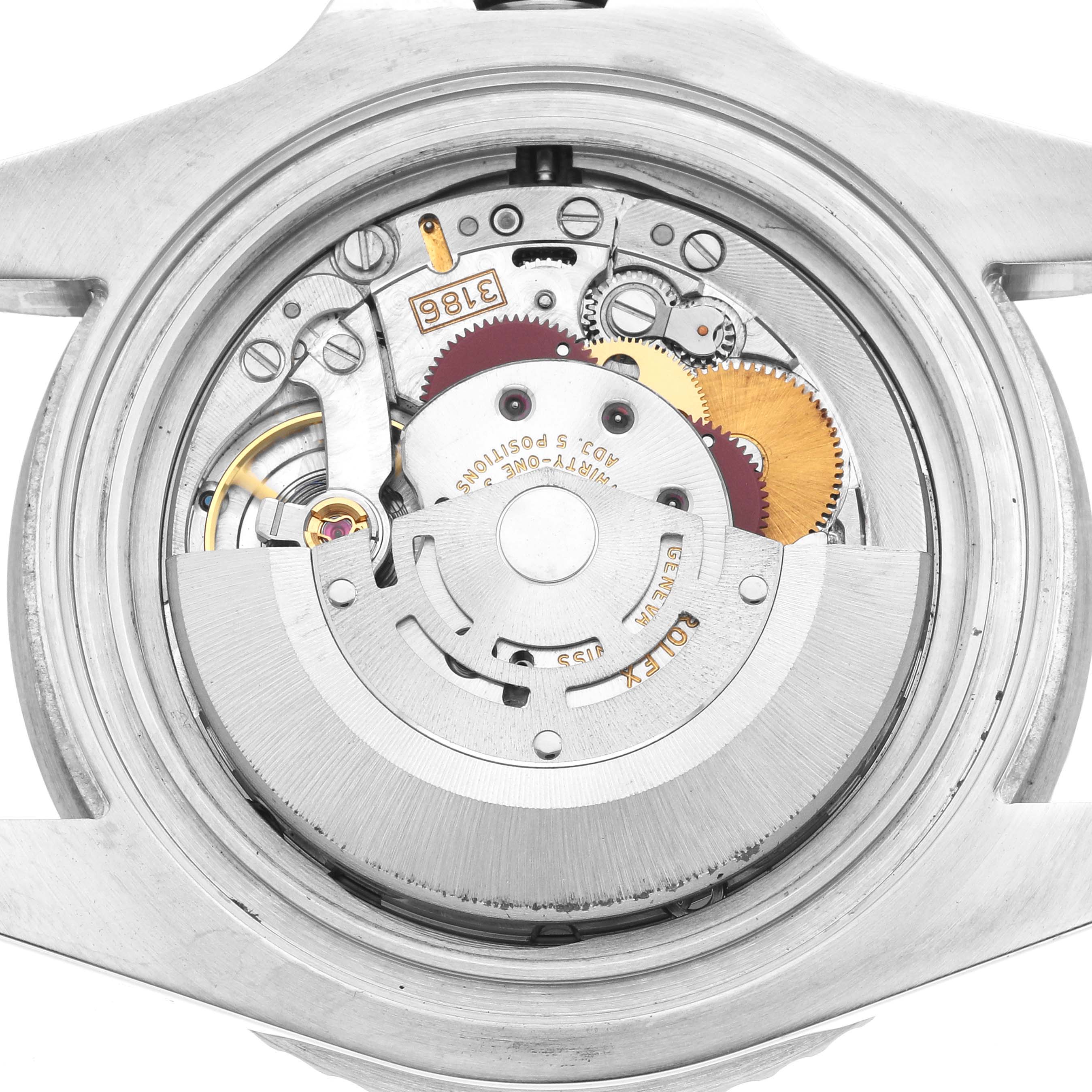 The image shows the Rolex GMT-Master 116710LN Men's Stainless Steel Black Dial watch's movement from a back angle, highlighting gears and the rotor.