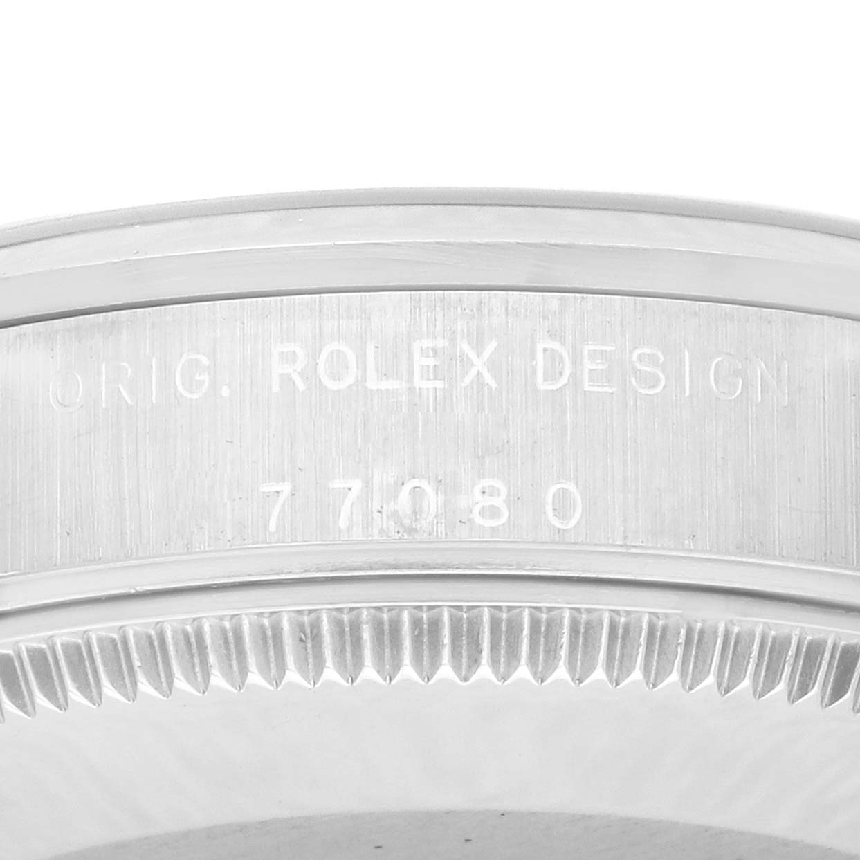 The image shows a close-up of the side engraving on a Rolex Mid-Size 77080 Women's Stainless Steel Black Dial 77080 Women's Stainless Steel Black Dial model, displaying "ORIG. ROLEX DESIGN" and the number "77080".