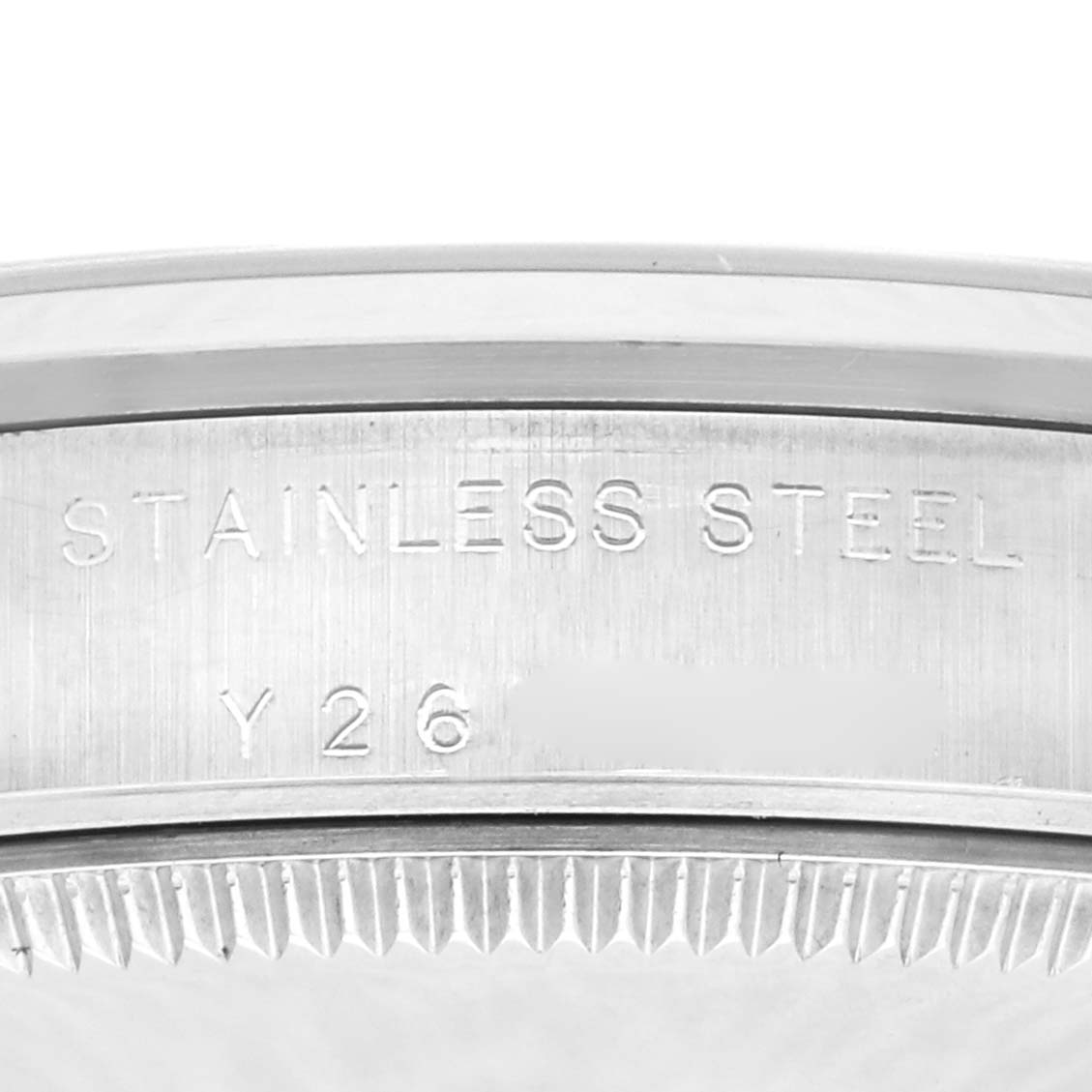 The image shows a close-up of the edge and inner engraving on the bezel of a Rolex Mid-Size 77080 Women's Stainless Steel Black Dial 77080 Women's Stainless Steel Black Dial watch, emphasizing "STAINLESS STEEL."