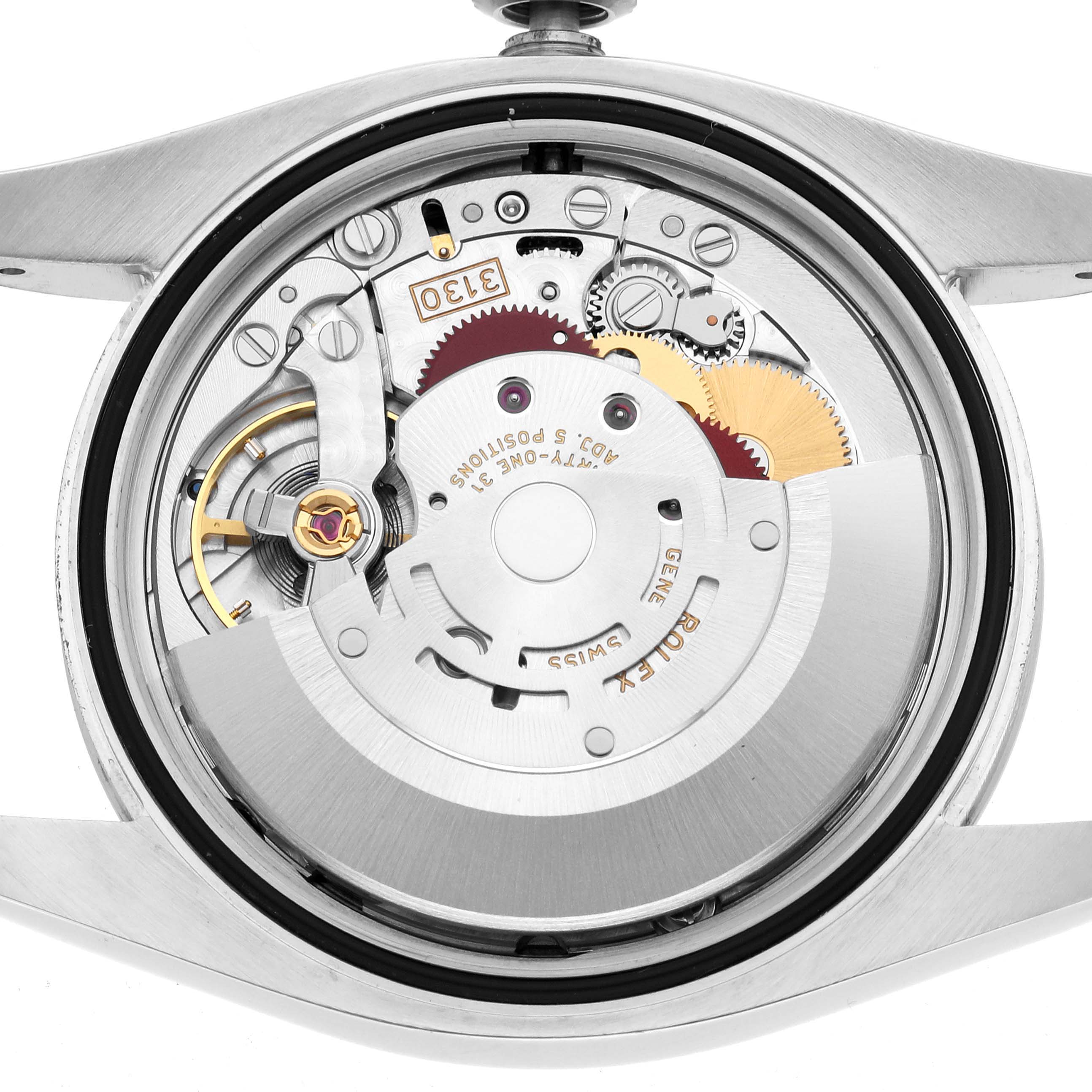 The image shows the intricate internal movement of a Rolex Oyster Perpetual 116000 Men
s Stainless Steel Champagne Dial watch from a top-down angle.