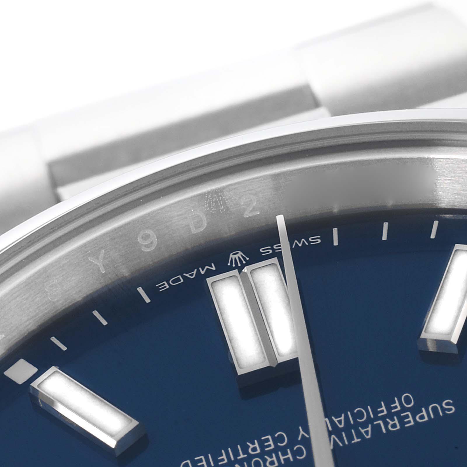 This image shows a close-up of the dial and part of the bracelet of a Rolex Oyster Perpetual 124300 Men's Stainless Steel Blue Dial 124300 Men's Stainless Steel Blue Dial watch.