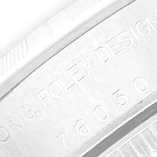 This image shows a close-up of the inner bezel of the Oyster Perpetual Rolex watch displaying the model and brand engraving.