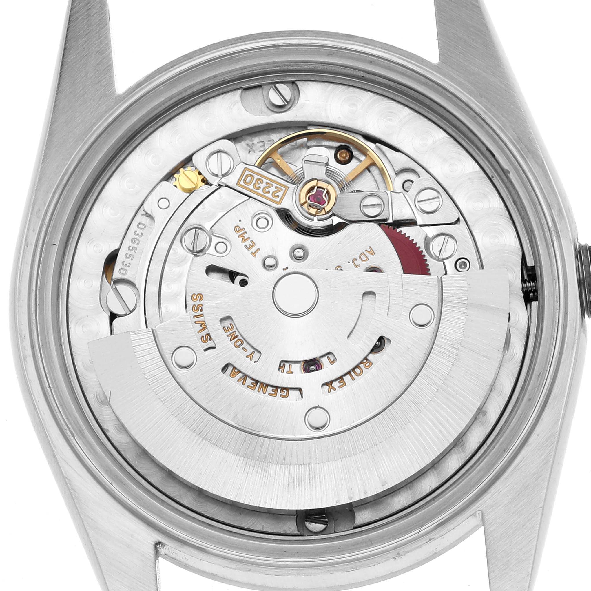 The image shows a back view of a Rolex Mid-Size 77080 Women
s Stainless Steel Blue Dial watch, highlighting its intricate movement and rotor.