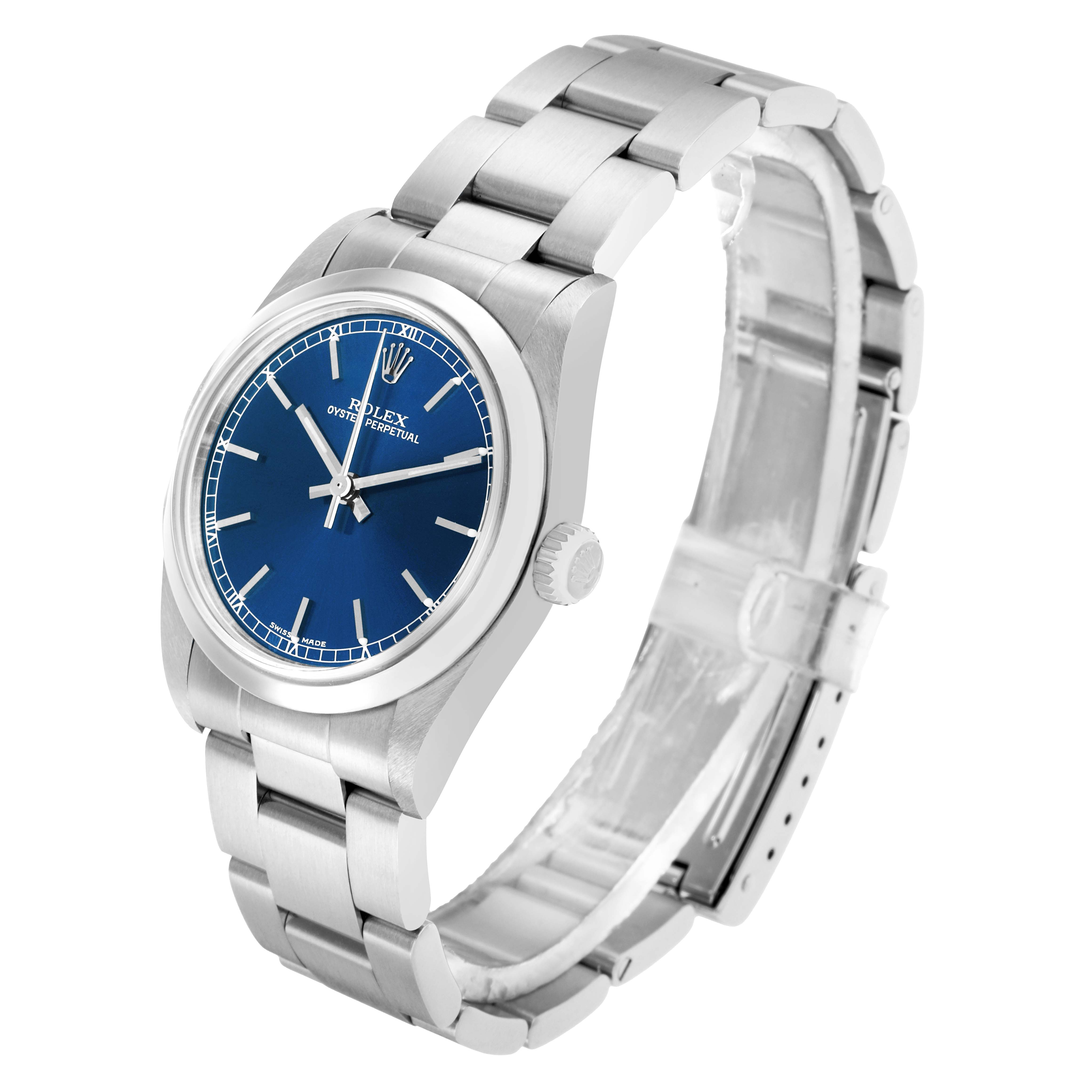 The Rolex Mid-Size 77080 Women
s Stainless Steel Blue Dial watch is shown from a three-quarter angle, displaying the face, bezel, crown, and bracelet.