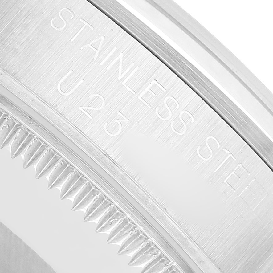 The image shows the side view of the Rolex Oyster Perpetual 67480 Women's Stainless Steel Pink Dial watch's case, highlighting the brushed stainless steel surface.