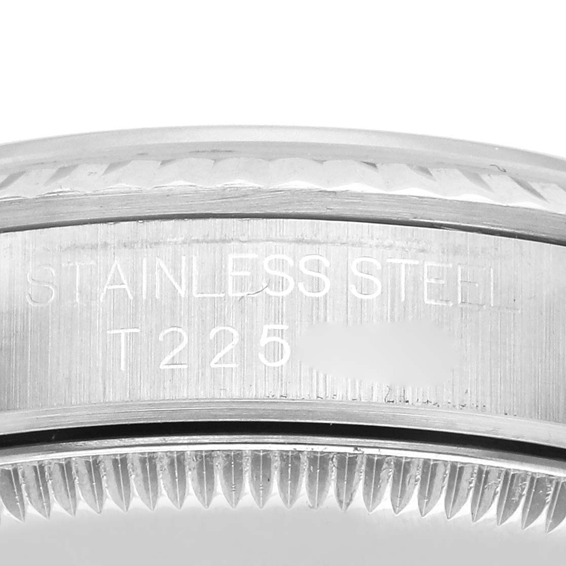 The image shows the engraved side of a mid-size stainless steel Rolex watch case.