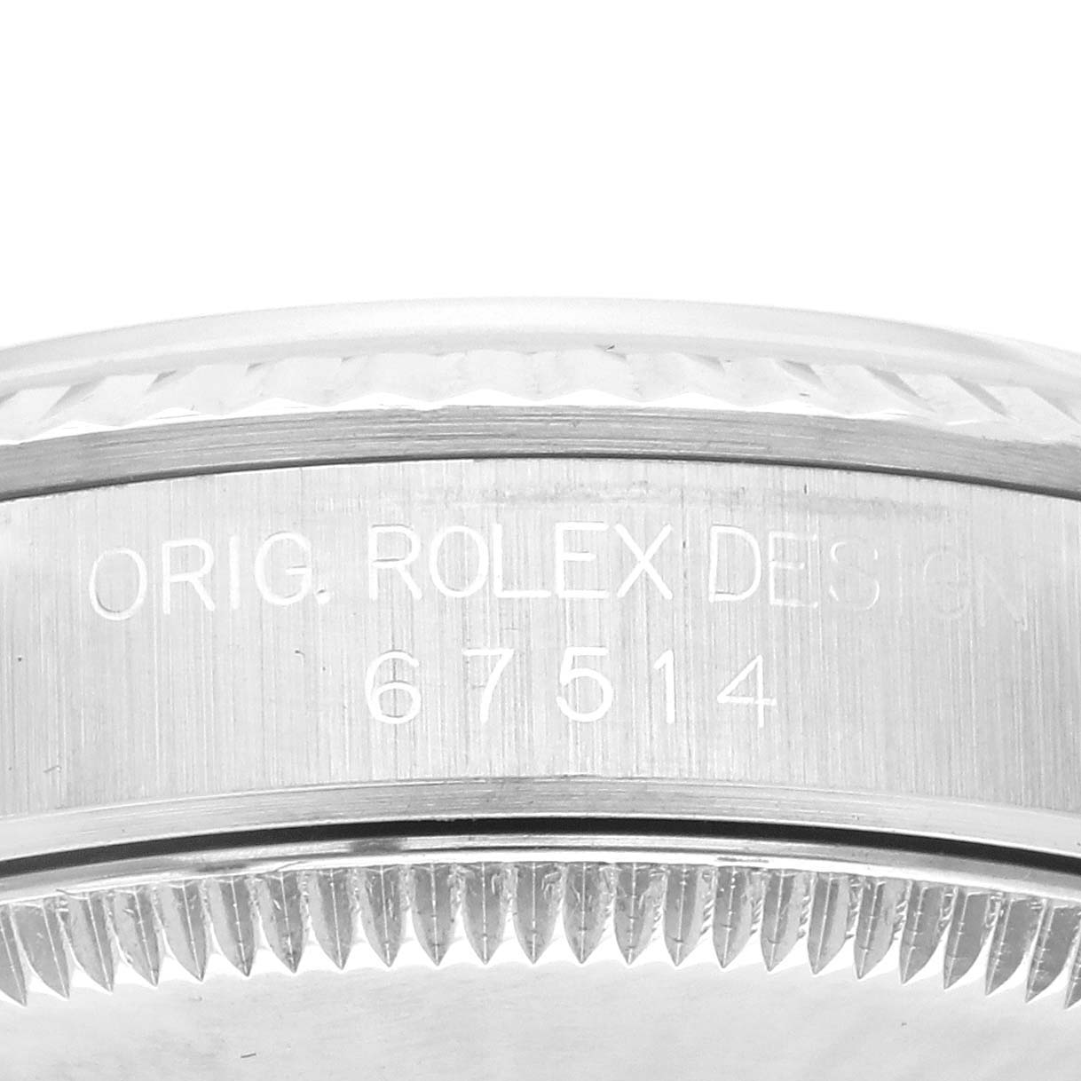 The image shows the side view of a Rolex Mid-Size 67514 Women's Stainless Steel White Dial 67514 Women's Stainless Steel White Dial model, focusing on the bezel and serial engraving.