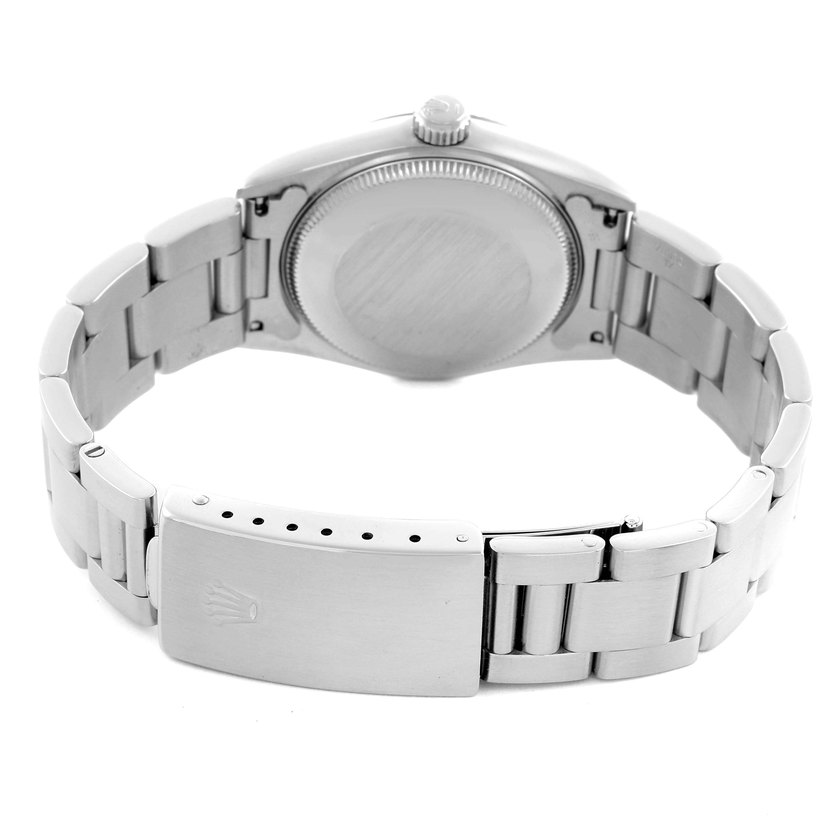 The image shows the back and bracelet of a Mid-Size Rolex watch, highlighting the clasp and case back.