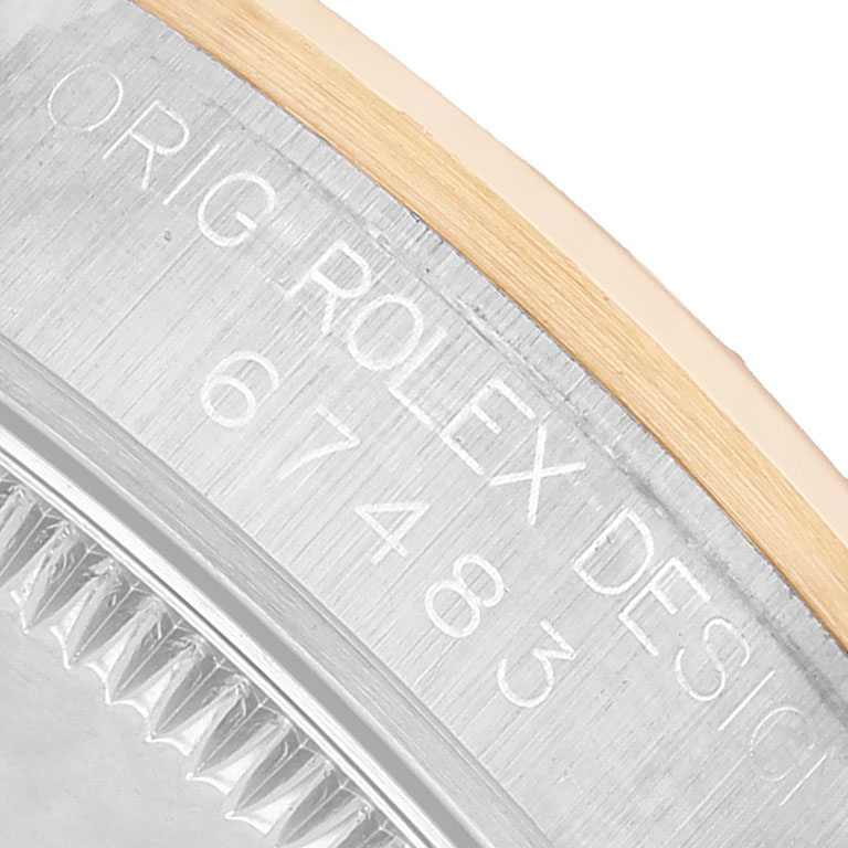 The image shows a close-up of the case side of a Rolex Oyster Perpetual 67483 Women's Steel and Gold (two tone) Blue Dial, highlighting the engravings.