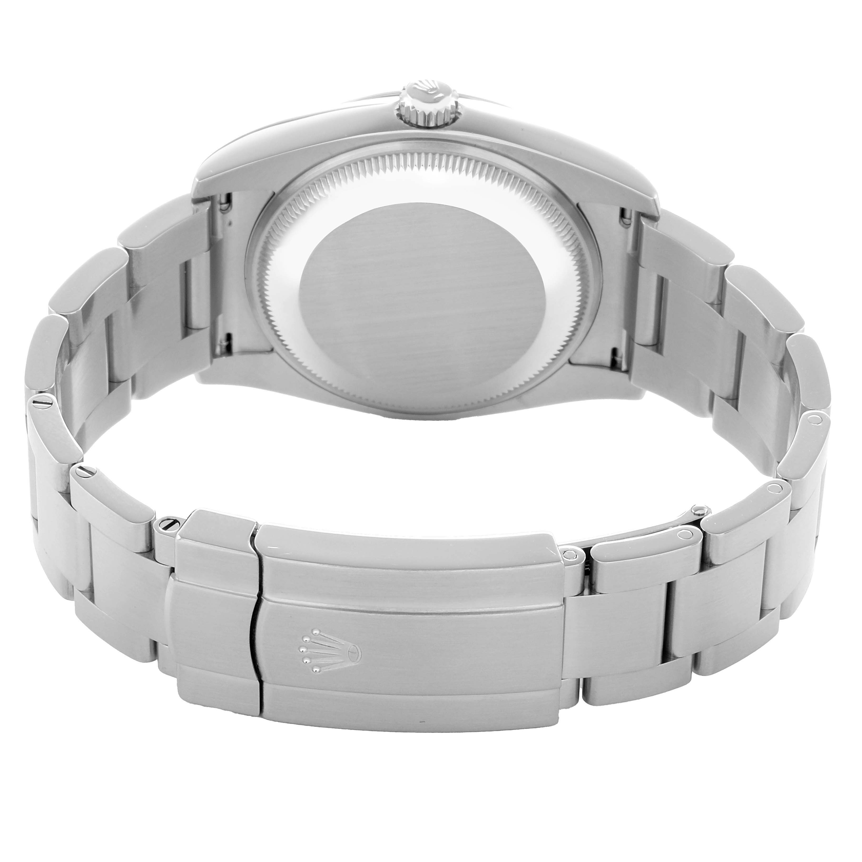 The image shows the back view of a Rolex Oyster Perpetual 114200 Men's Stainless Steel Green Dial watch, highlighting the clasp and stainless steel bracelet.