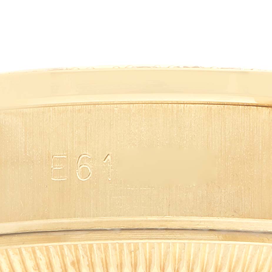 The image shows a close-up of the side engraving on the case of a Rolex President 69138 Women
s Yellow Gold Champagne Dial watch.