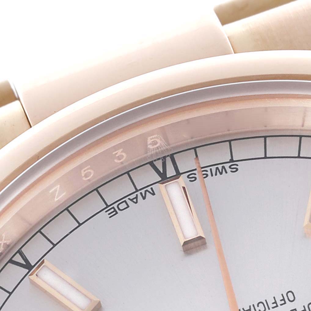 This close-up image shows part of the dial and bezel of a Rolex President 118205 Men's Rose Gold Silver Dial 118205 Men's Rose Gold Silver Dial watch at an oblique angle.