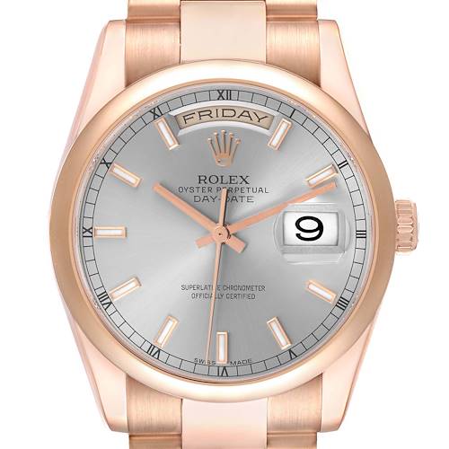 The Rolex President model is shown from the front, highlighting the face, bezel, crown, and partial bracelet.