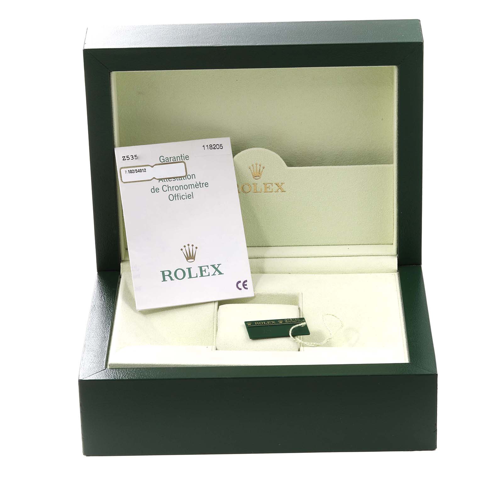 The image shows an open Rolex President 118205 Men's Rose Gold Silver Dial 118205 Men's Rose Gold Silver Dial watch box with papers and a green tag inside.