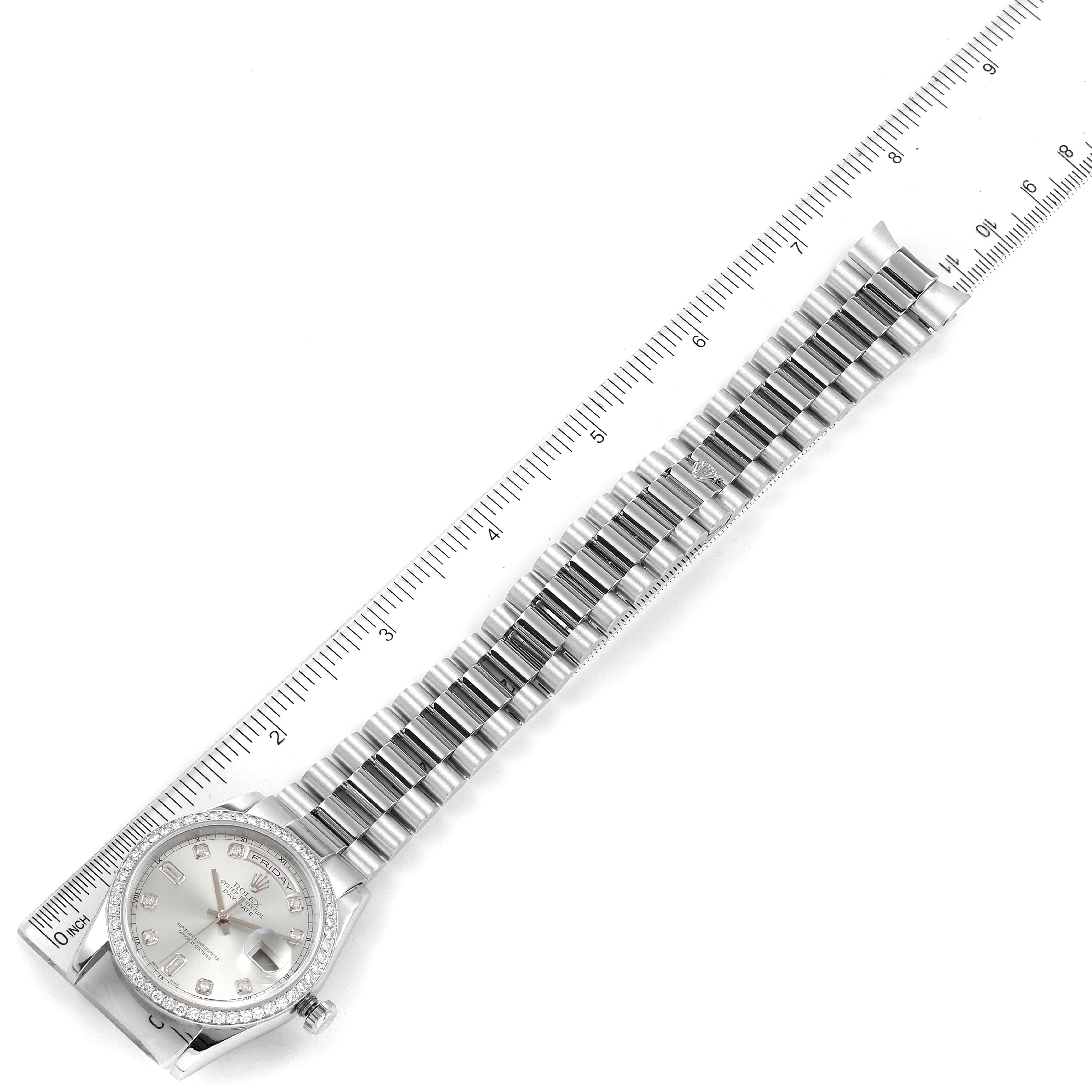 A top-down view of a Rolex President 118346 Men's Platinum Silver Dial 118346 Men's Platinum Silver Dial model watch showing its face, bezel, and entire bracelet next to a ruler for scale.