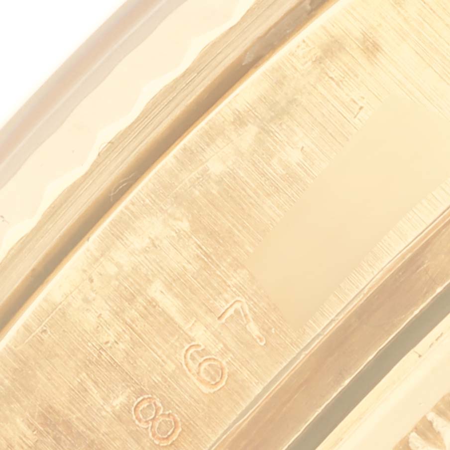 This image shows a close-up of the side of a Rolex President 18038 Men
s Yellow Gold Champagne Dial 18038 Men
s Yellow Gold Champagne Dial watch, focusing on the fluted bezel and edge.