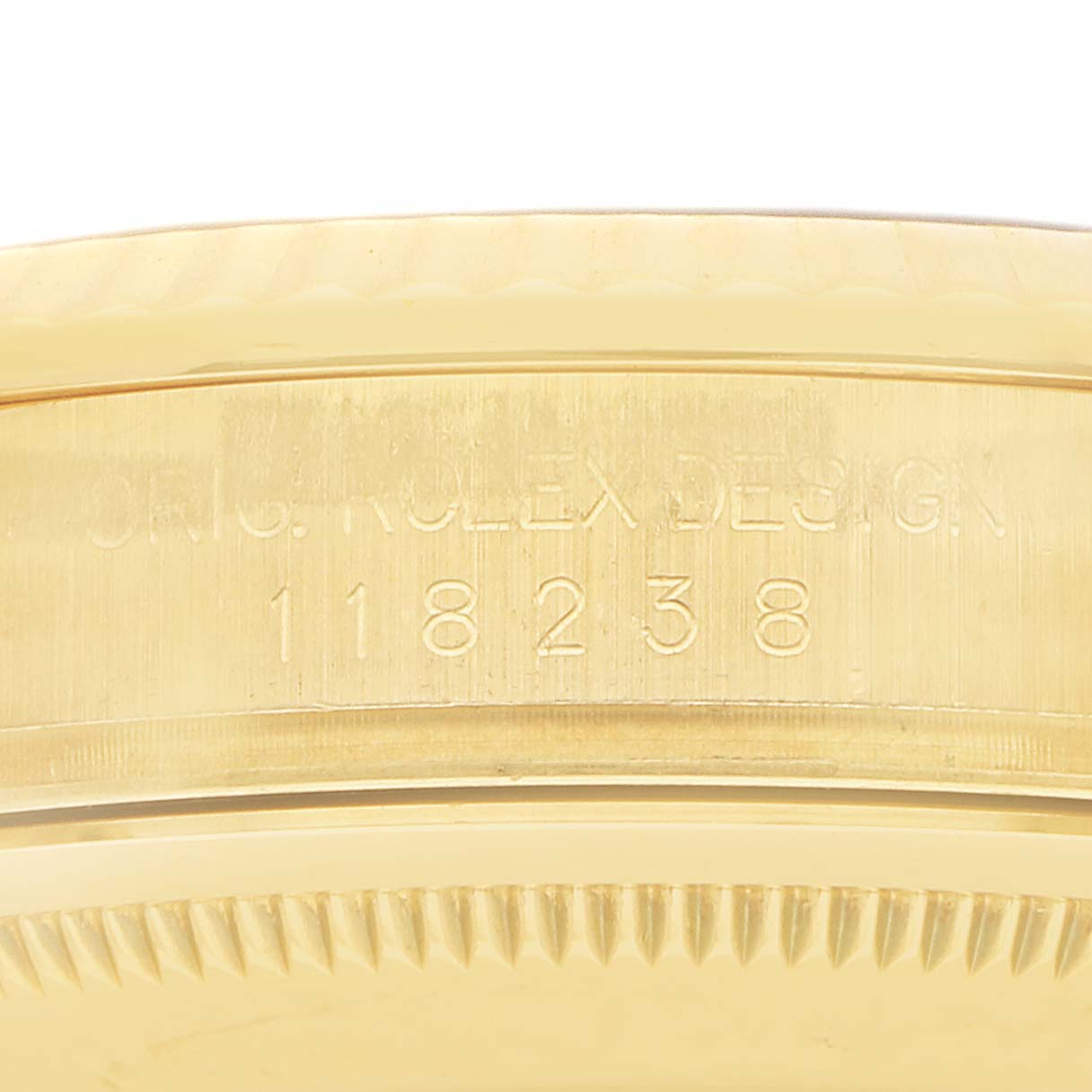 The image shows the side of a Rolex President 118238 Men
s Yellow Gold Champagne Dial watch, highlighting the model number and engraved markings.